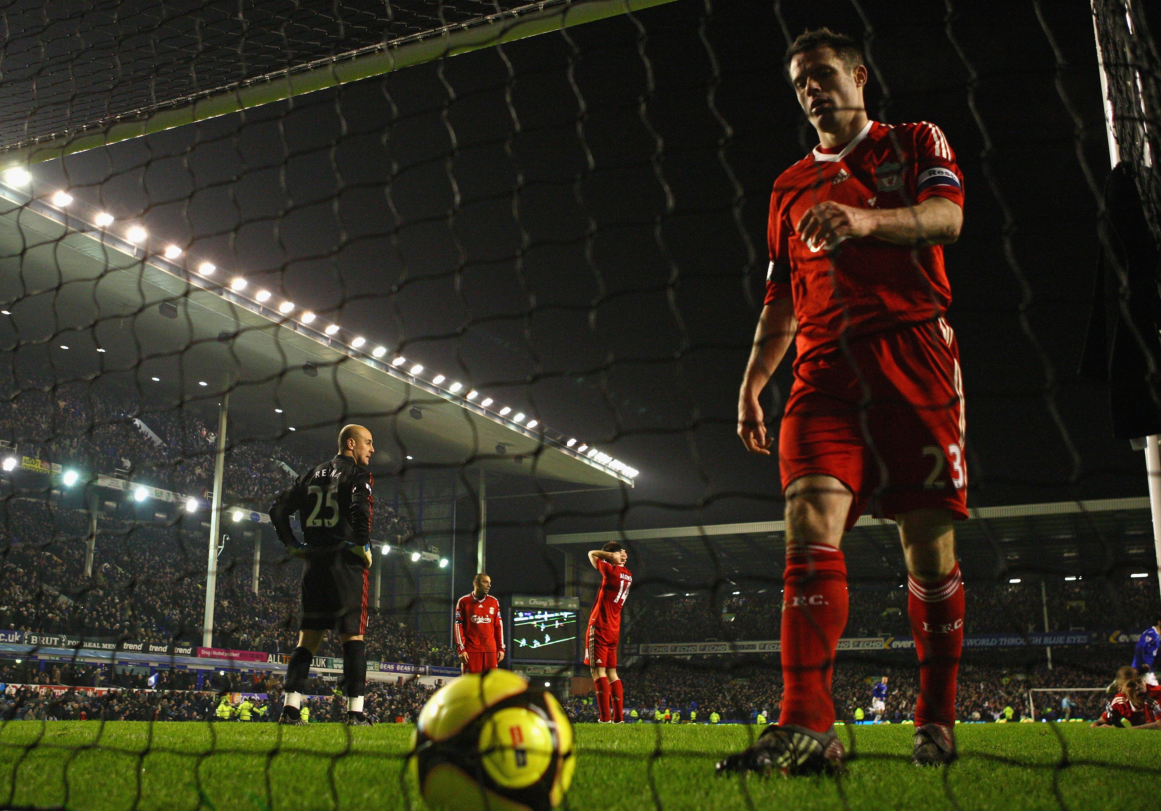 LIVERPOOL, UNITED KINGDOM - FEBRUARY 04:  Jamie Carragher of Liverpool looks dejected as he collects the ball from the back of the net after Dan Gosling of Everton had scored the winning goal during the FA Cup fourth round replay match sponsored by e.on b