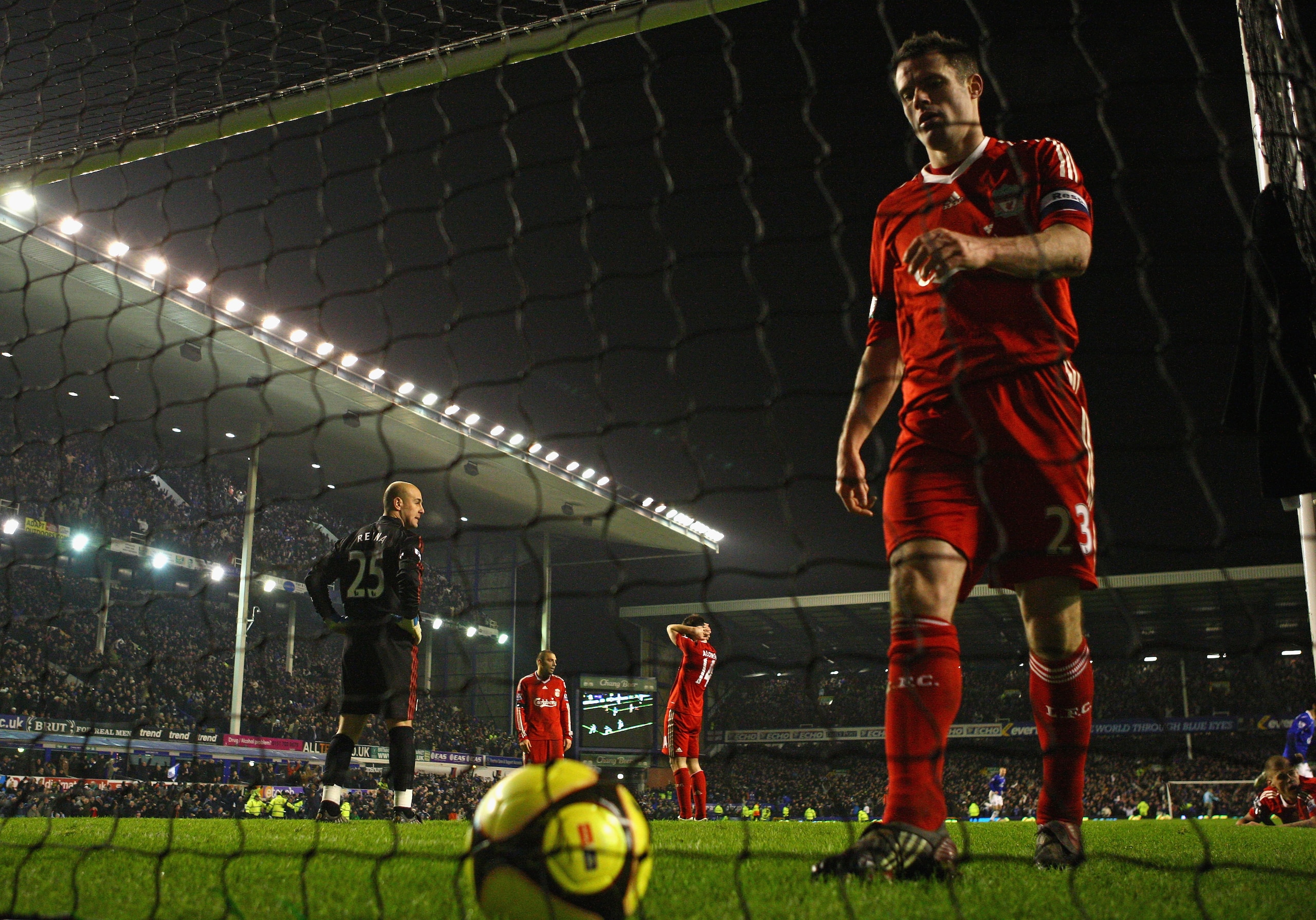 LIVERPOOL, UNITED KINGDOM - FEBRUARY 04:  Jamie Carragher of Liverpool looks dejected as he collects the ball from the back of the net after Dan Gosling of Everton had scored the winning goal during the FA Cup fourth round replay match sponsored by e.on b