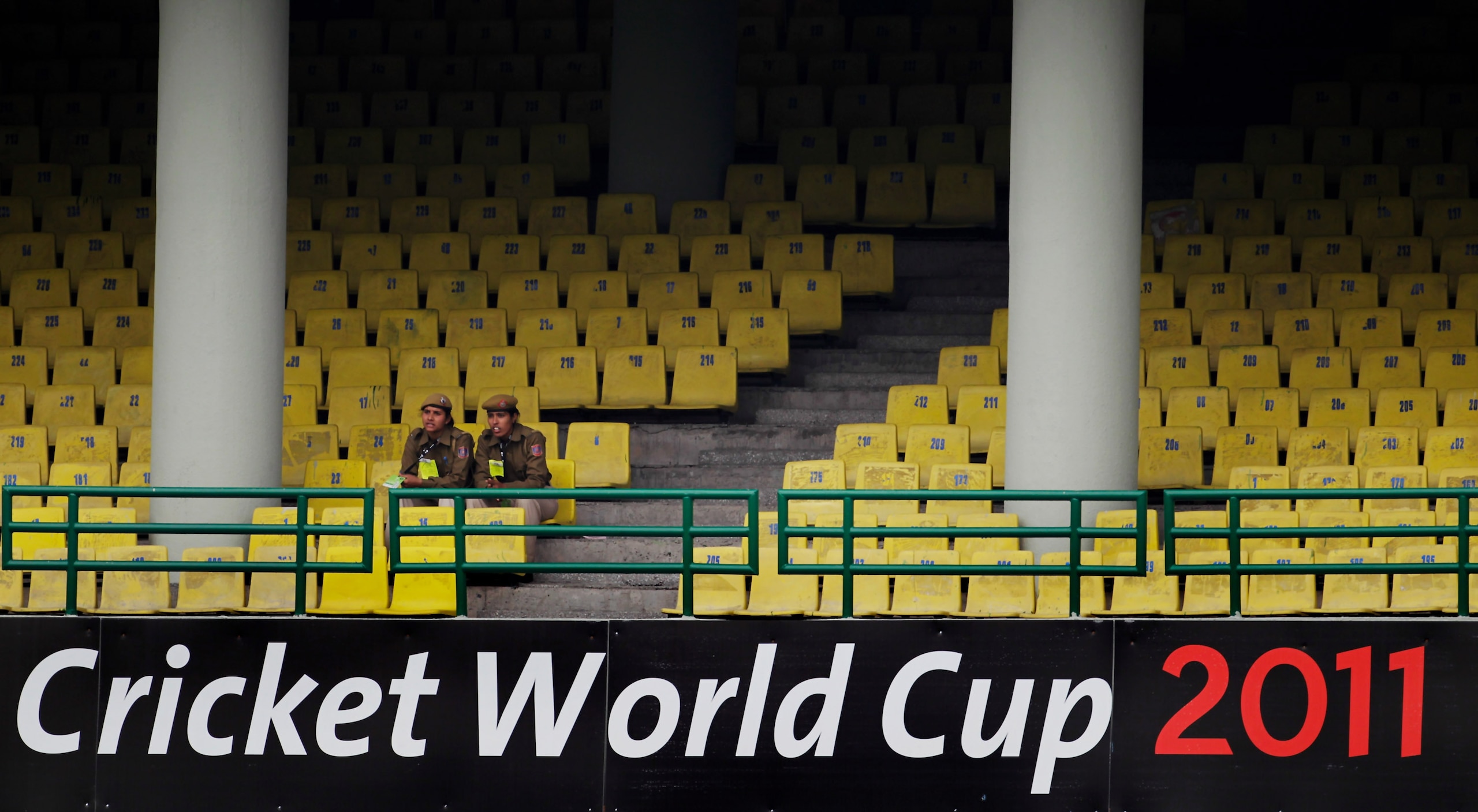 DELHI, INDIA - FEBRUARY 28: Police officers sit in the empty stands during the 2011 ICC World Cup group B match between Netherlands and West Indies at Feroz Shah Kotla stadium on February 28, 2011 in Delhi, India.  (Photo by Daniel Berehulak/Getty Images)