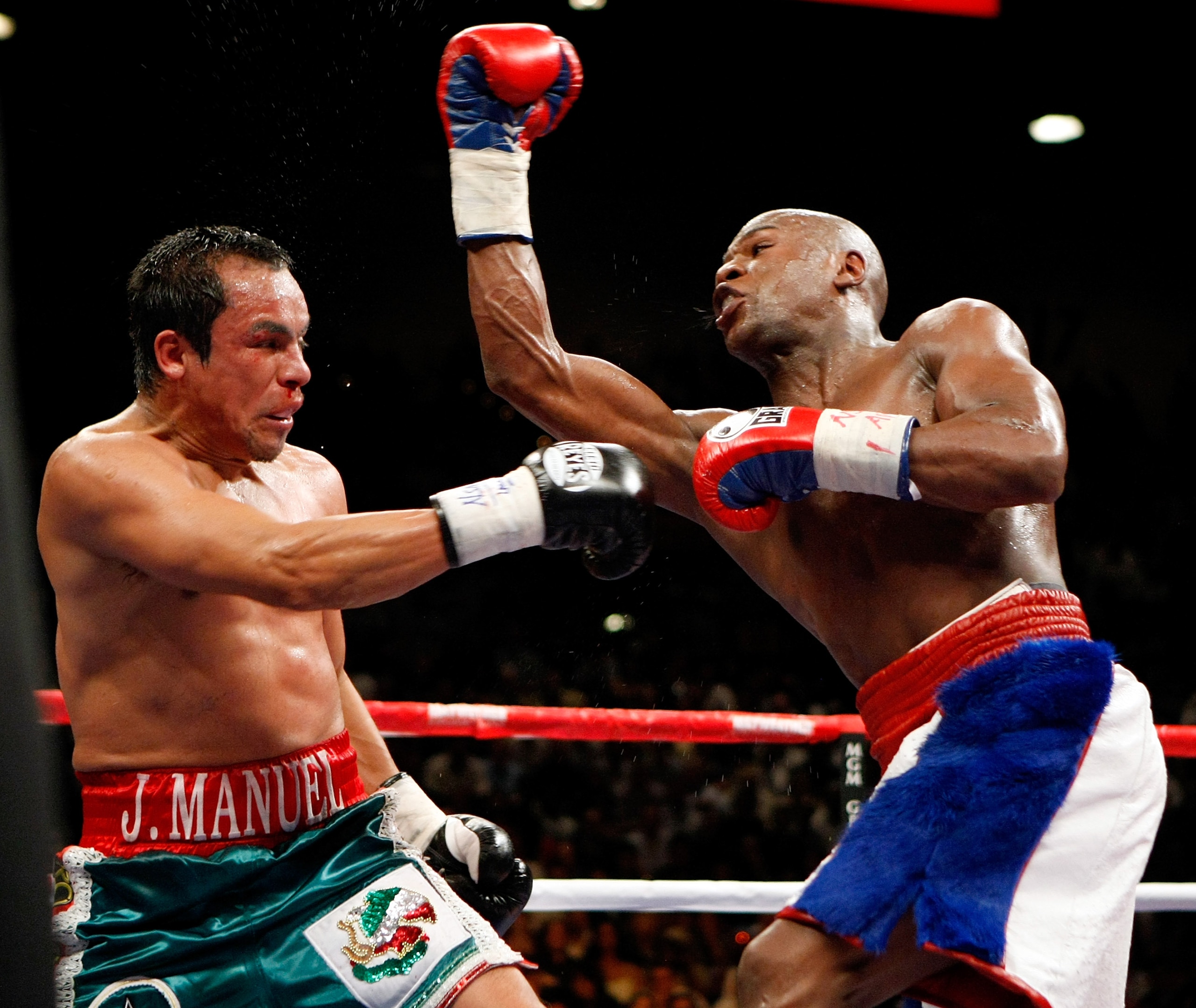 LAS VEGAS - SEPTEMBER 19:  Floyd Mayweather Jr. (R) throws a punch at Juan Manuel Marquez in the sixth round of their fight at the MGM Grand Garden Arena September 19, 2009 in Las Vegas, Nevada. Mayweather won by unanimous decision.  (Photo by Ethan Mille