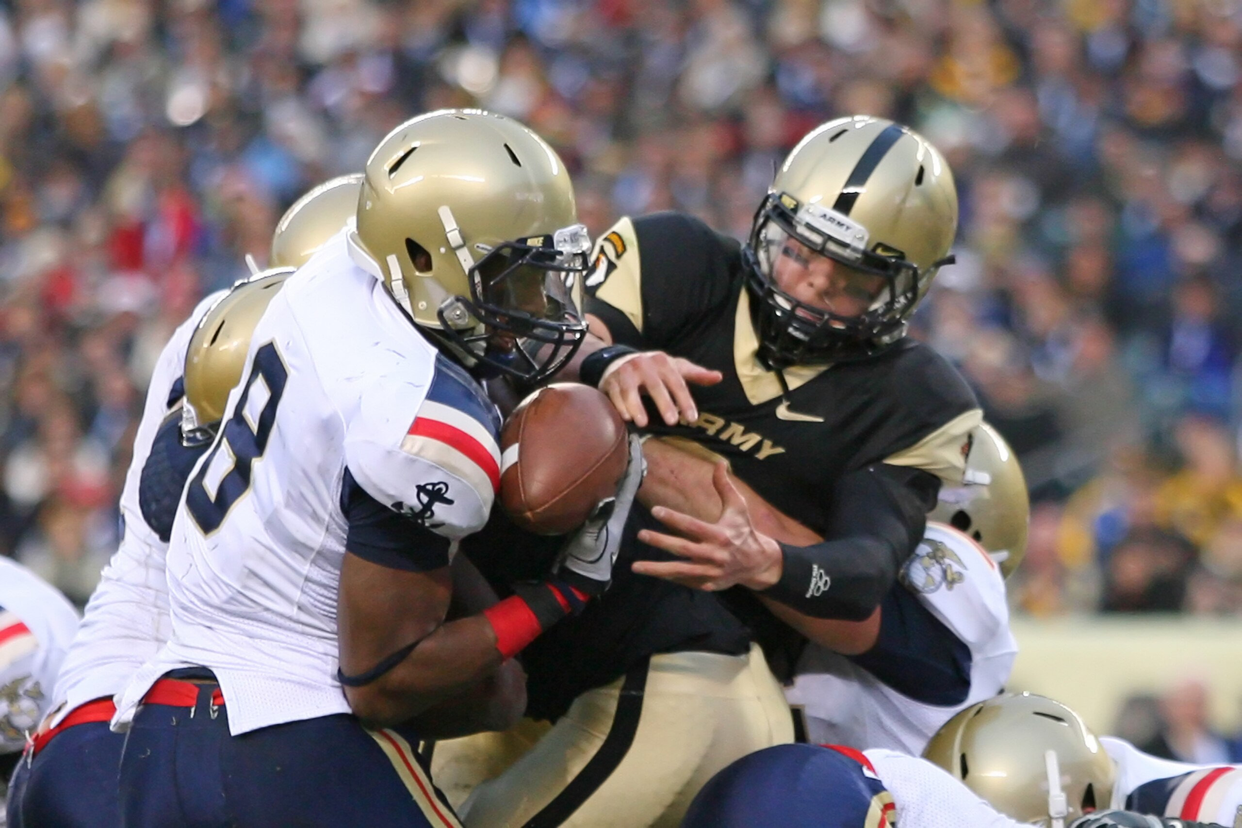PHILADELPHIA - DECEMBER 11: Quarterback Trent Steelman #8 of the Army Black Knights is stripped of the ball by safety Wyatt Middleton #8 of the Navy Midshipmen during the game on December 11, 2010 at Lincoln Financial Field in Philadelphia, Pennsylvania.