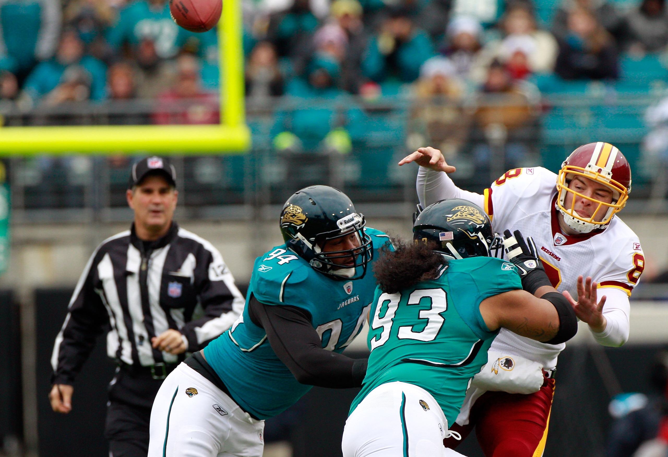 JACKSONVILLE, FL - DECEMBER 26:  Quarterback Rex Grossman #8 of the Washington Redskins is pressured by Tyson Alualu #93 and Jeremy Mincey #94 of the Jacksonville Jaguars during the game at EverBank Field on December 26, 2010 in Jacksonville, Florida.  (P