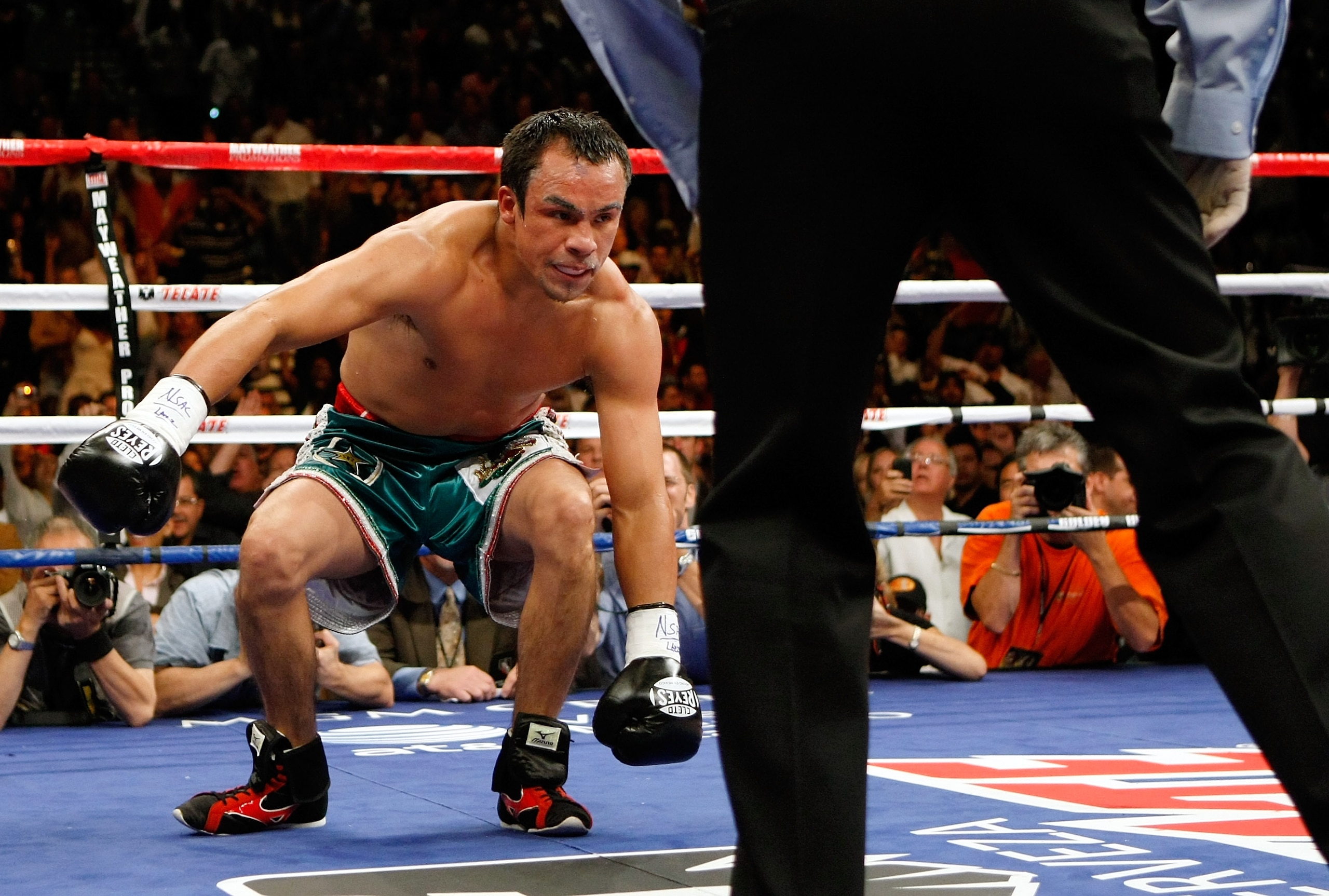 LAS VEGAS - SEPTEMBER 19:  Juan Manuel Marquez gets up off the canvas after he was knocked down by Floyd Mayweather Jr. in the second round of their fight at the MGM Grand Garden Arena September 19, 2009 in Las Vegas, Nevada. Mayweather won by unanimous d