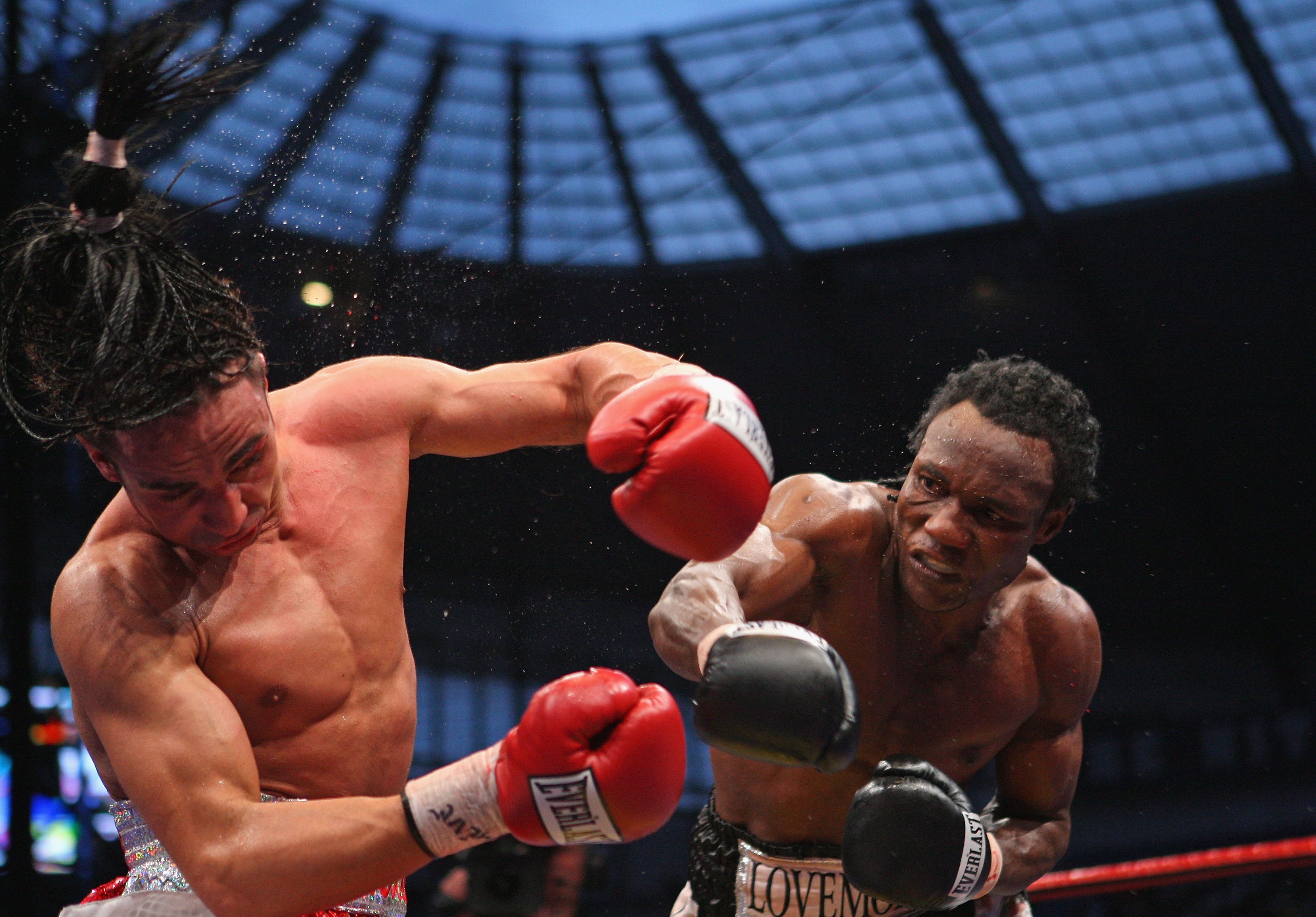 MANCHESTER, UNITED KINGDOM - MAY 24:  Lovemore N'Dou hits Paulie Malignaggi with a right hand shot during the IBF light-welterweight championship fight between Paulie Malignaggi and Lovemore N'Dou at the City of Manchester Stadium on May 24, 2008 in Manch