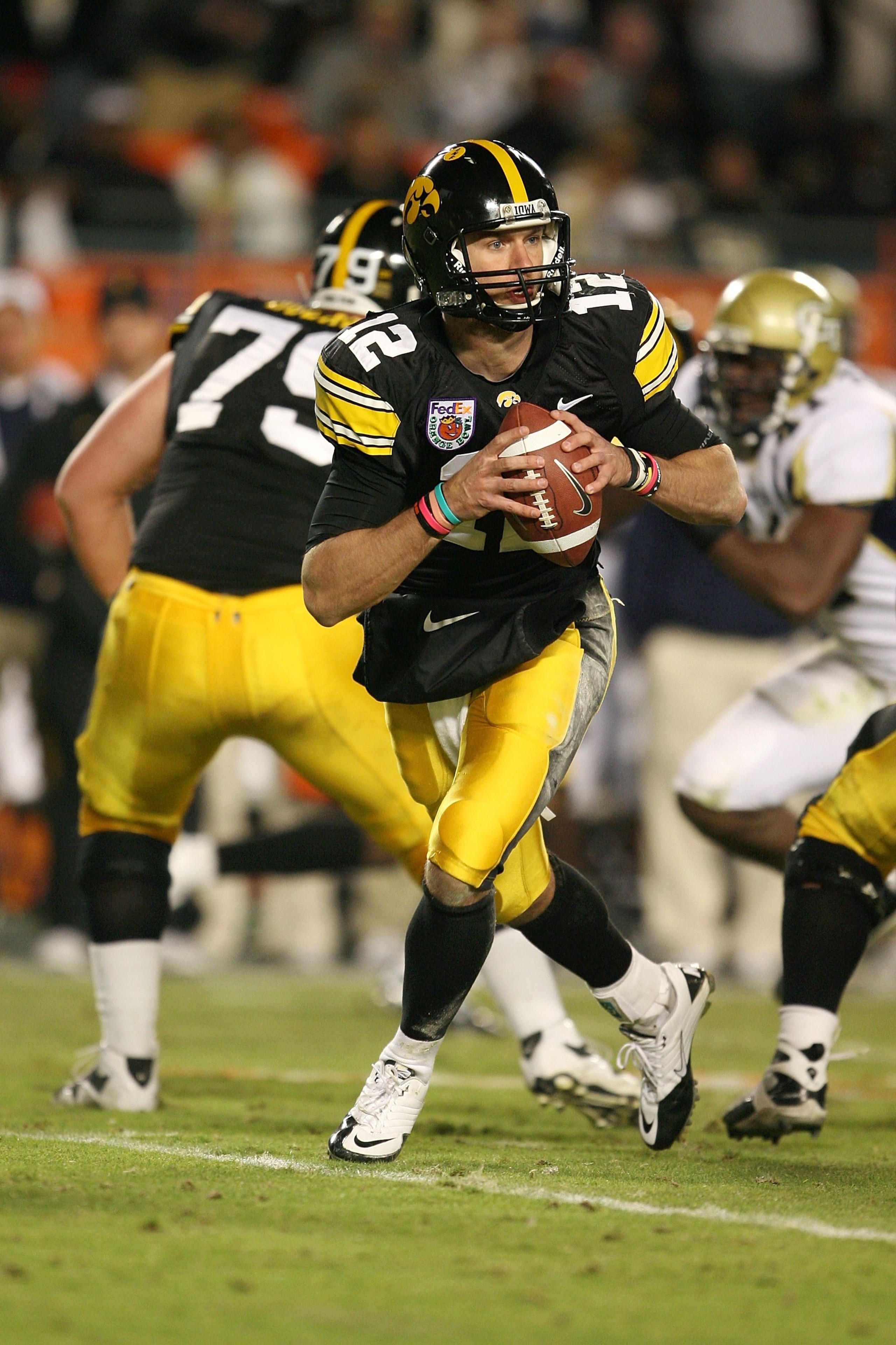 MIAMI GARDENS, FL - JANUARY 05:  Quarterback Ricky Stanzi #12 of the Iowa Hawkeyes rolls out to pass against the Georgia Tech Yellow Jackets during the FedEx Orange Bowl at Land Shark Stadium on January 5, 2010 in Miami Gardens, Florida. Iowa won 24-14.