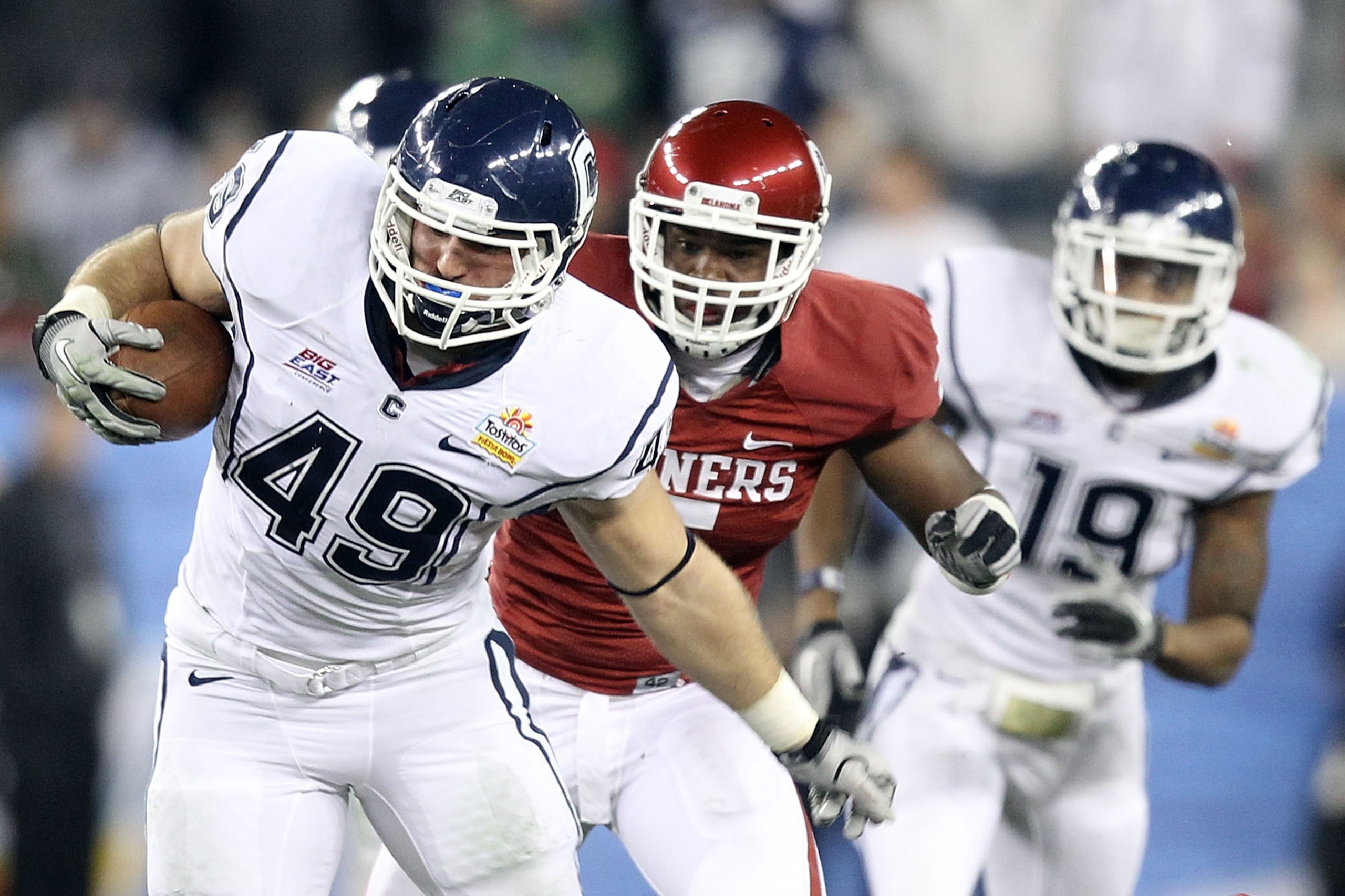 GLENDALE, AZ - JANUARY 01:  Anthony Sherman #49 of the Connecticut Huskies runs the ball in the fourth quarter against the Oklahoma Sooners during the Tostitos Fiesta Bowl at the Universtity of Phoenix Stadium on January 1, 2011 in Glendale, Arizona.  (Ph
