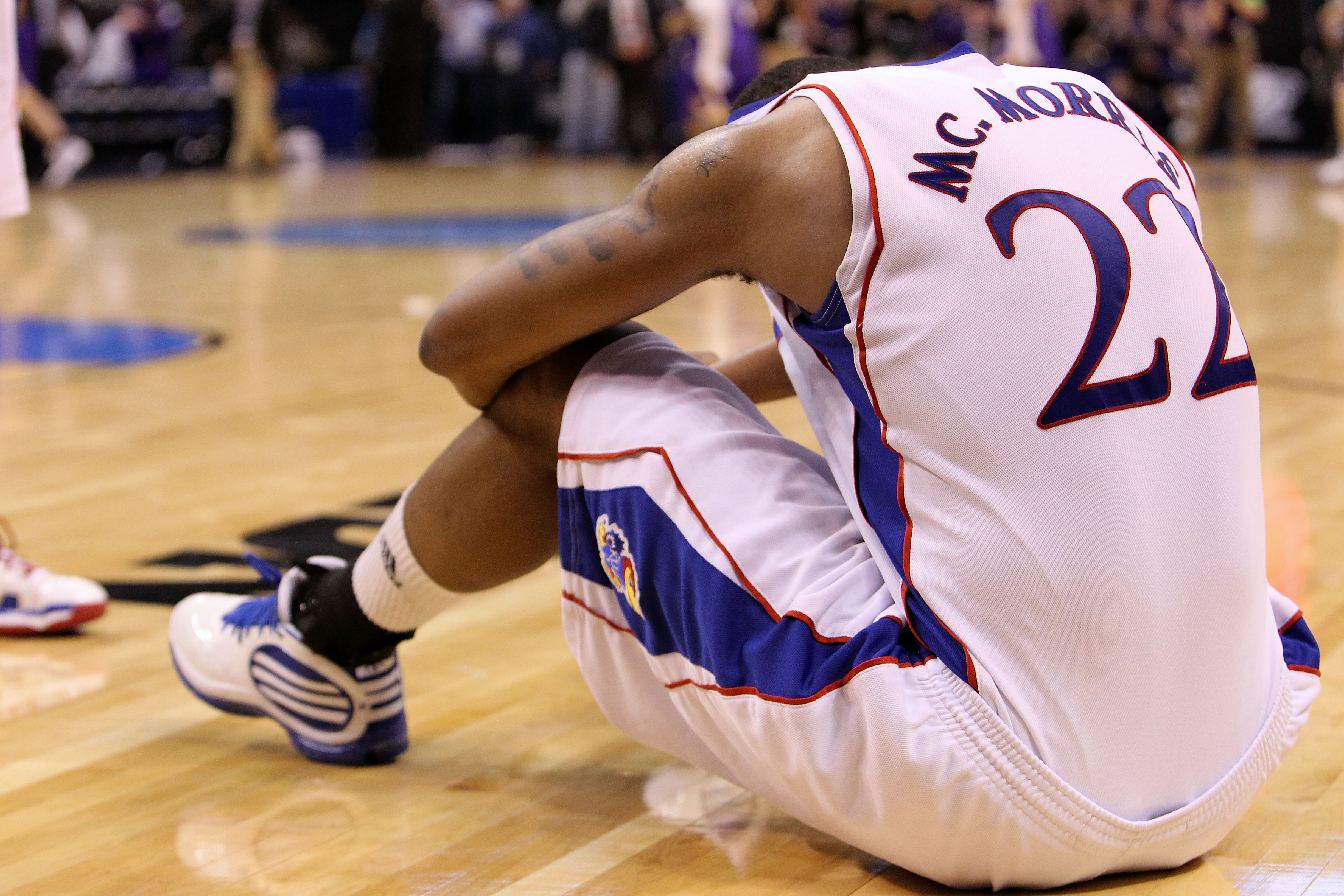 OKLAHOMA CITY - MARCH 20: Marcus Morris #22 of the Kansas Jayhawks remains on the court dejected after they lost 69-67 against the Northern Iowa Panthers during the second round of the 2010 NCAA men's basketball tournament at Ford Center on March 20, 201