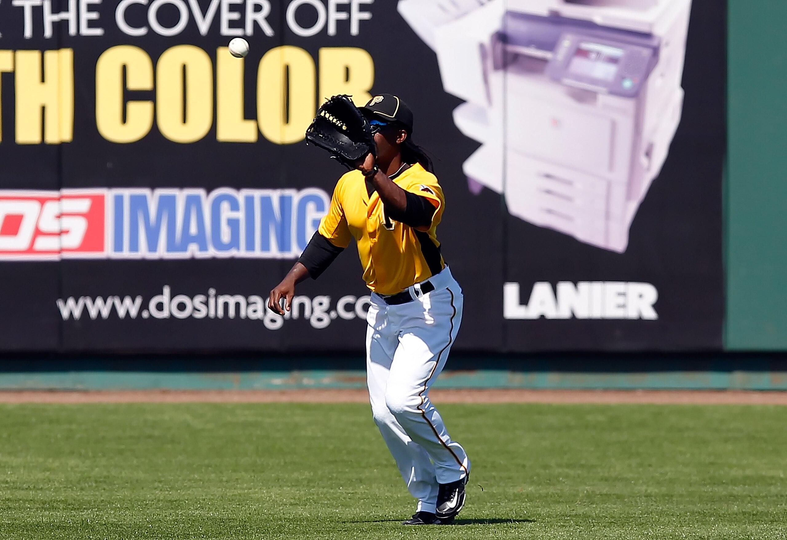 BRADENTON, FL - FEBRUARY 28:  Outfielder Andrew McCutchen #22 of the Pittsburgh Pirates catches a fly ball against the Baltimore Orioles during a Grapefruit League Spring Training Game at McKechnie Field on February 28, 2011 in Bradenton, Florida.  (Photo