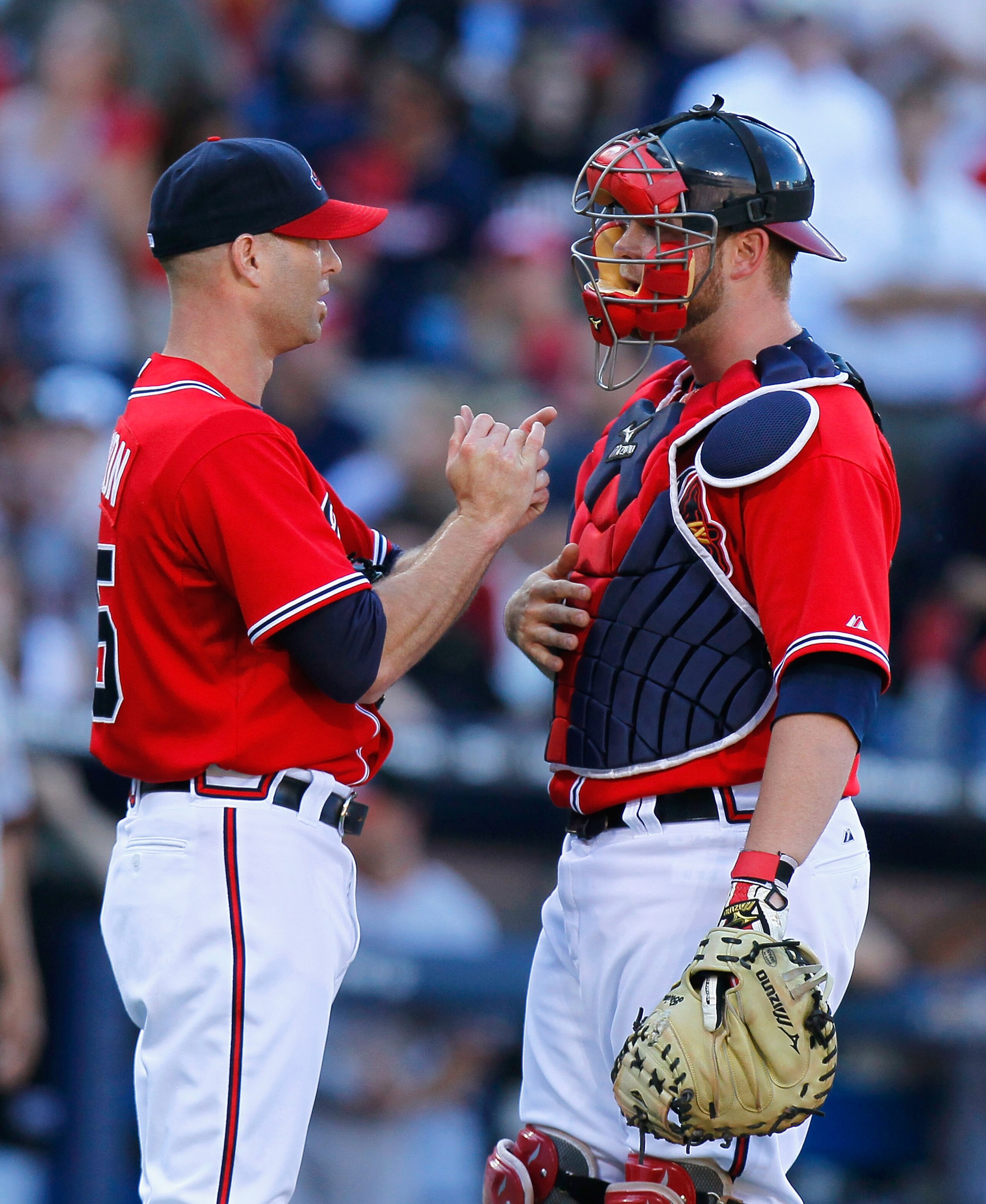 ATLANTA - OCTOBER 10:  Brian McCann #16 and pitcher Tim Hudson #15 of the Atlanta Braves against the San Francisco Giants during Game Three of the NLDS of the 2010 MLB Playoffs at Turner Field on October 10, 2010 in Atlanta, Georgia.  (Photo by Kevin C. C