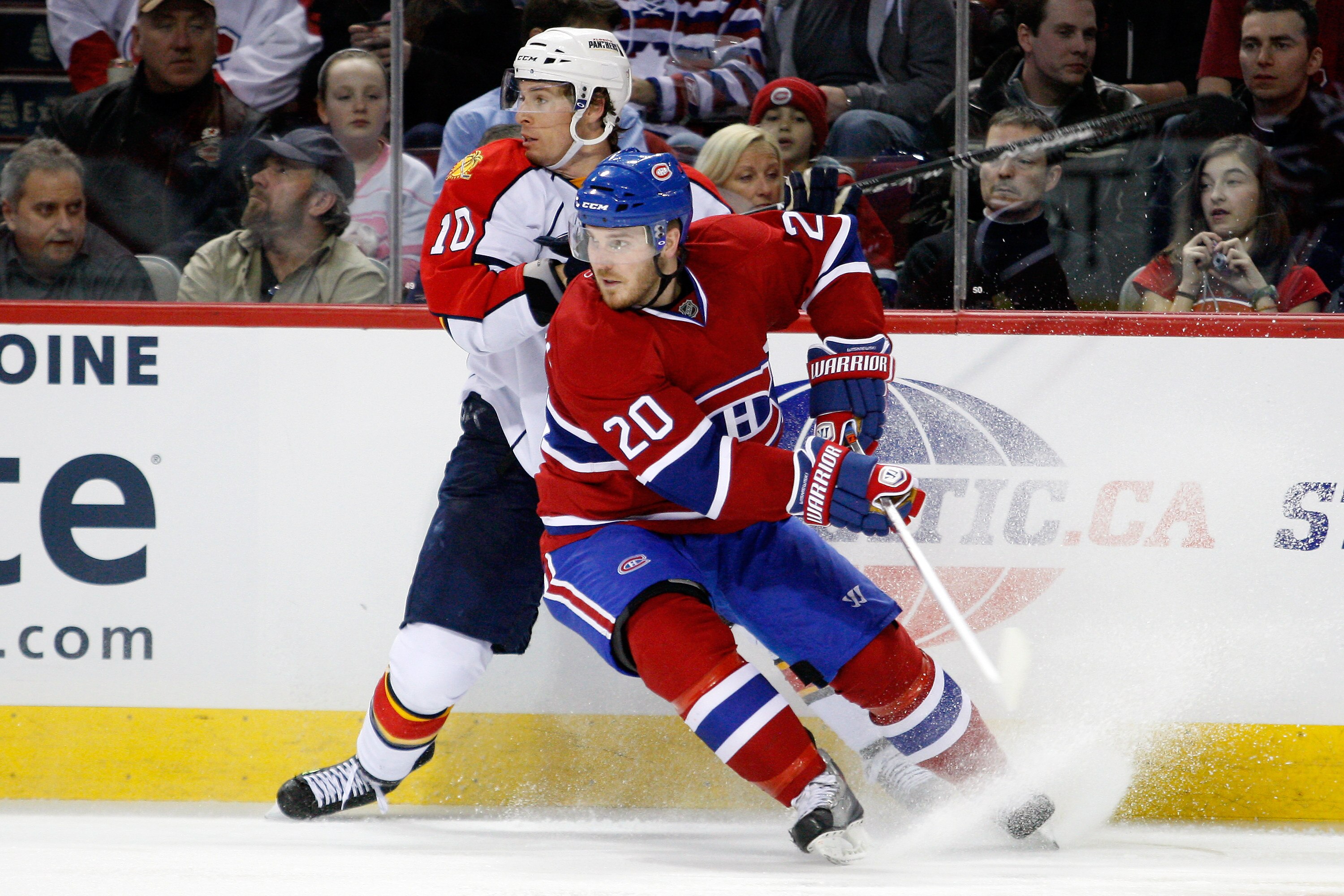 MONTREAL, CANADA - FEBRUARY 2:  James Wisniewski #20 of the Montreal Canadiens and David Booth #10 of the Florida Panthers both stop at the same time during the NHL game at the Bell Centre on February 2, 2011 in Montreal, Quebec, Canada.  The Canadiens de