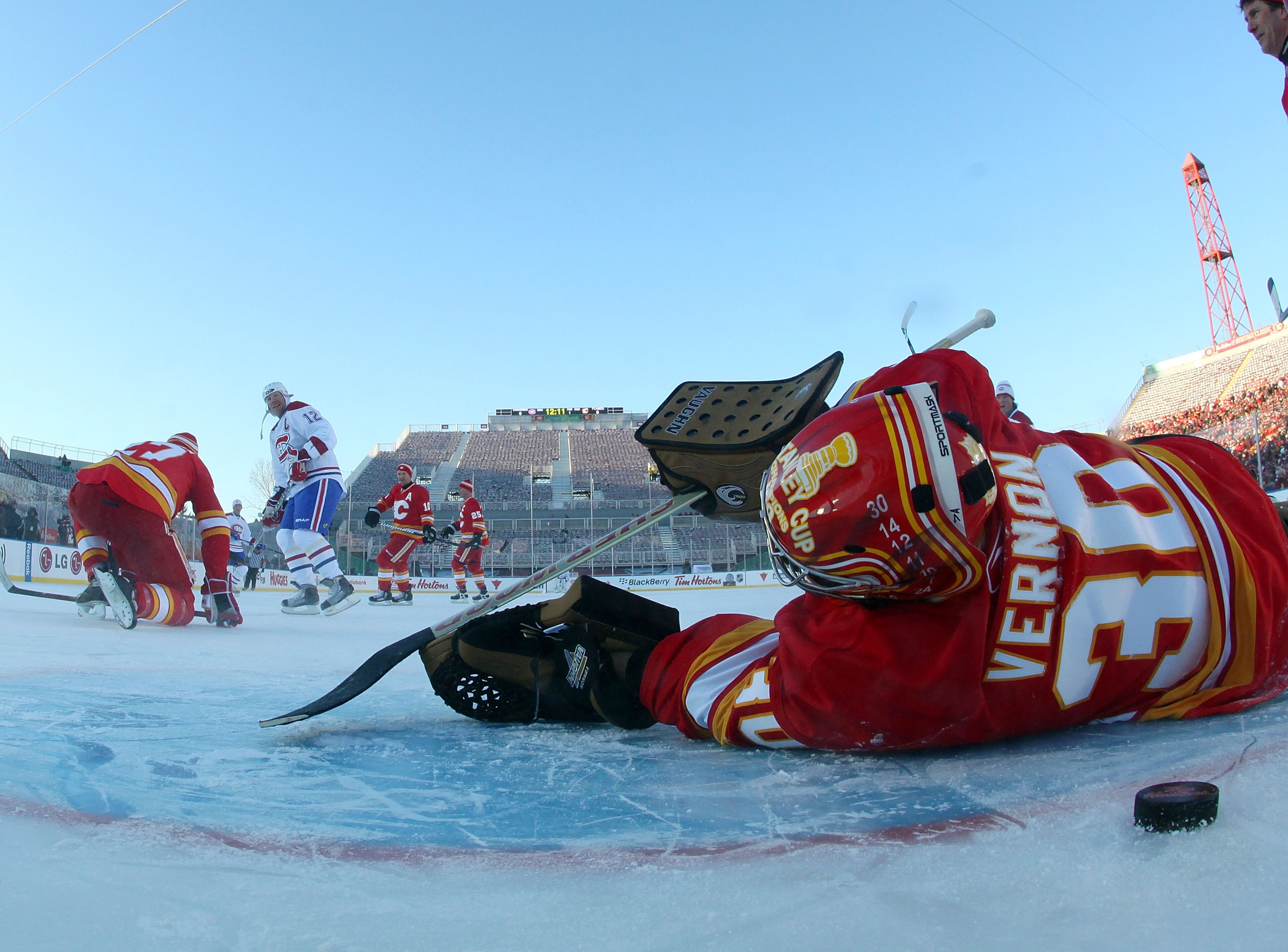 CALGARY, AB - FEBRUARY 19: Mike Keane #12 of the Montreal Canadiens Alumni watches a shot go past goaltender Mike Vernon #30 of the Calgary Flames Alumni during the Alumni game held as part of the 2011 NHL Heritage Classic festivities at McMahon Stadium CALGARY, AB - FEBRUARY 19: Mike Keane #12 of the Montreal Canadiens Alumni watches a shot go past goaltender Mike Vernon #30 of the Calgary Flames Alumni during the Alumni game held as part of the 2011 NHL Heritage Classic festivities at McMahon Stadium