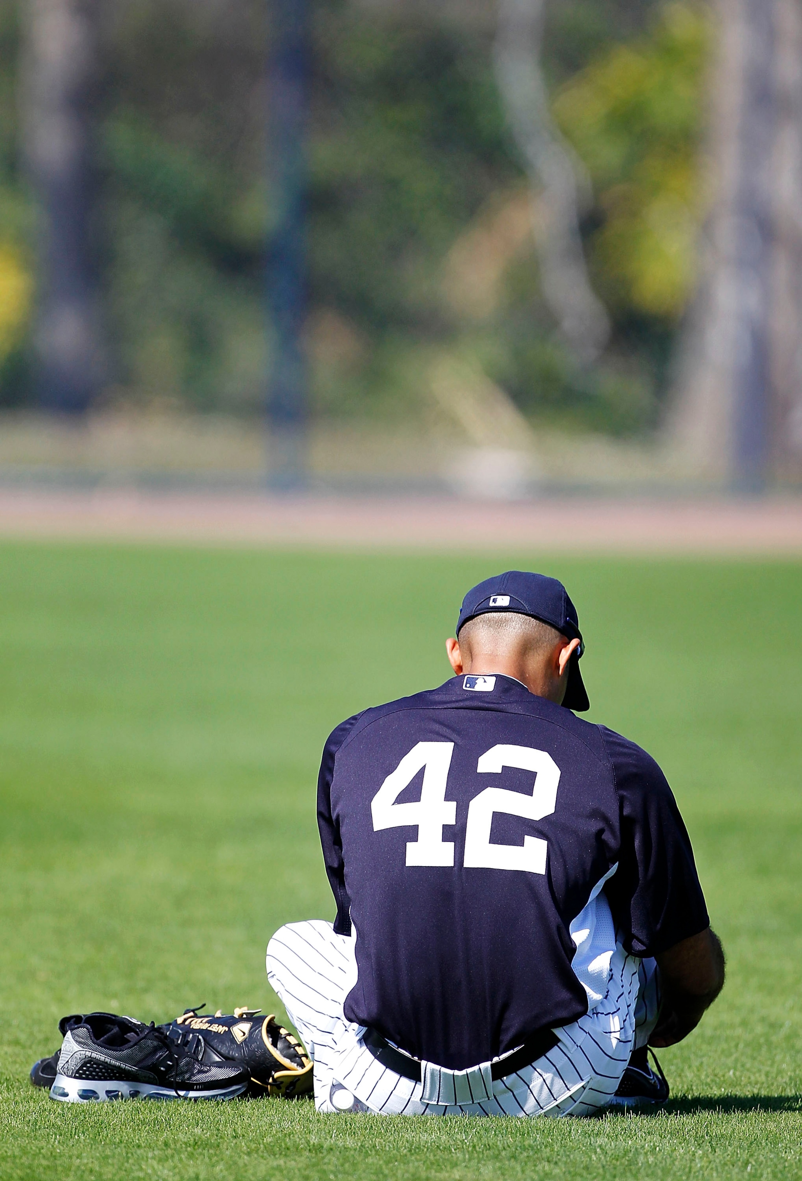 TAMPA, FL - FEBRUARY 21: Mariano Rivera #42 of the New York Yankees takes time out to change his shoes during the second day of full teams workouts at Spring Training on February 21, 2011 at the George M. Steinbrenner Field in Tampa, Florida.  (Photo by L