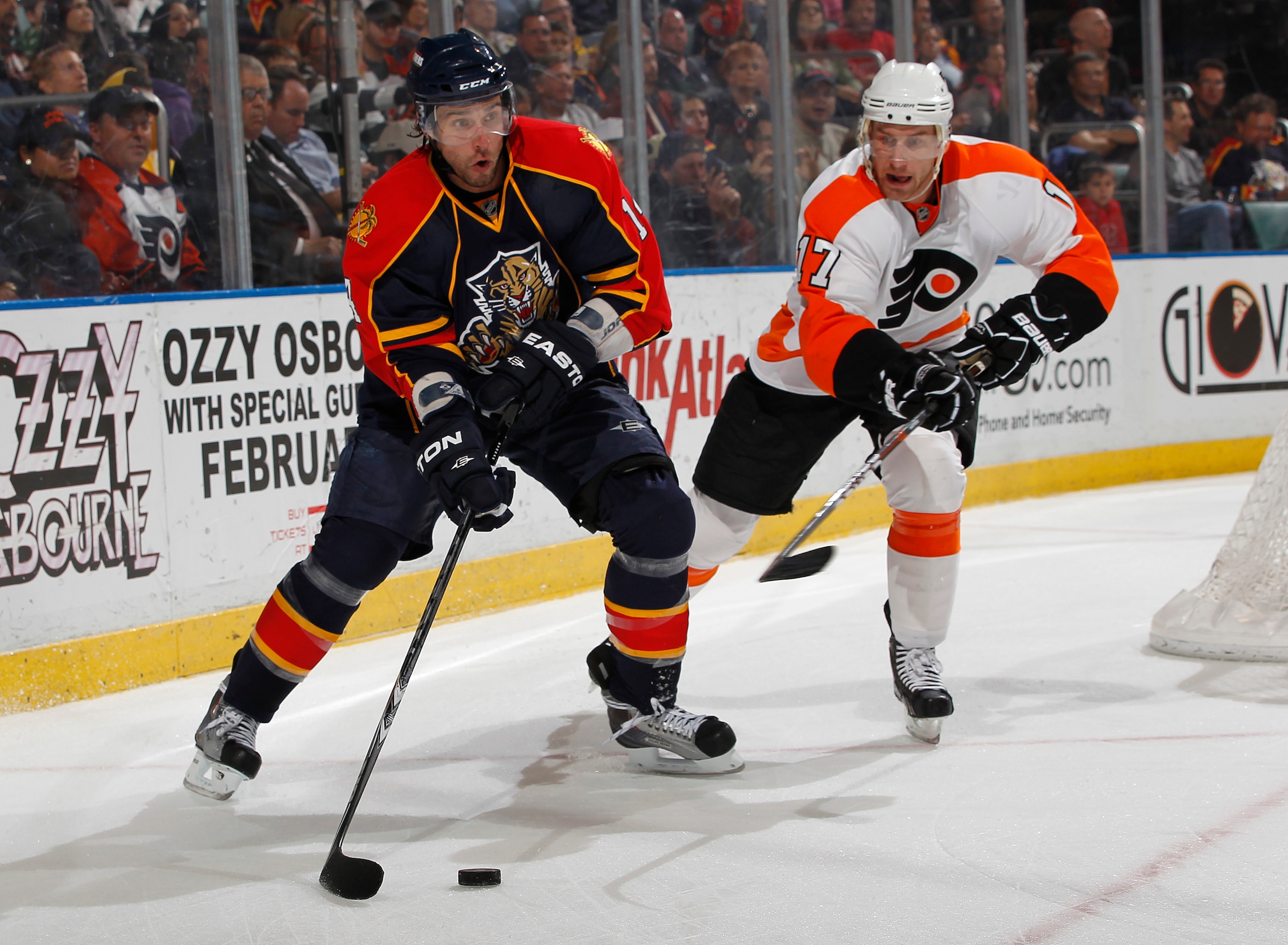 SUNRISE, FL - FEBRUARY 16: Radek Dvorak #14 of the Florida Panthers attempts to pass the puck in front of the net while being defended by Jeff Carter #17 of the Philadelphia Flyers on February 16, 2011 at the BankAtlantic Center in Sunrise, Florida. (Phot