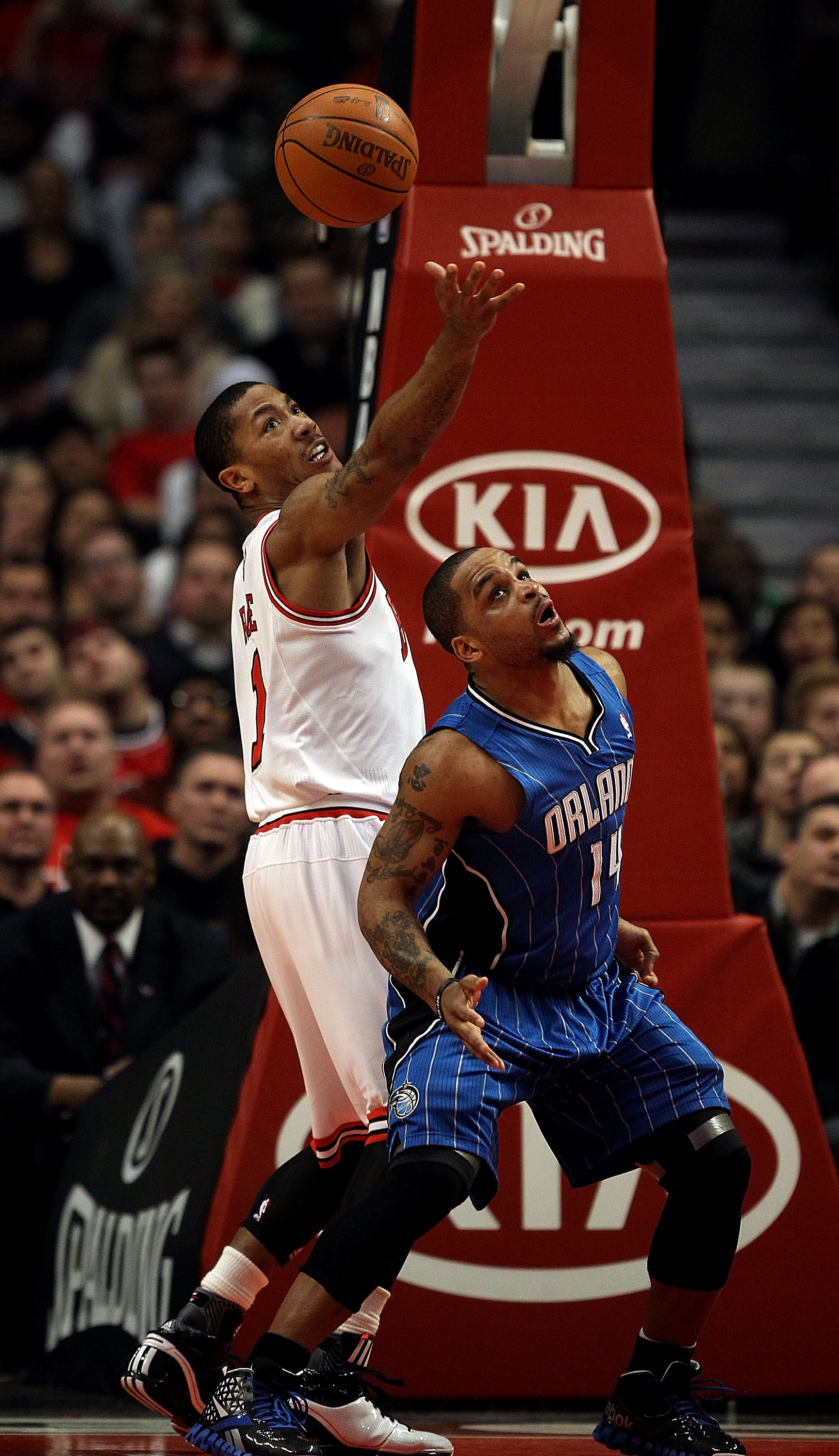 CHICAGO, IL - JANUARY 28: Derrick Rose #1 of the Chicago Bulls reaches for the ball over Jameer Nelson #14 of the Orlando Magic at the United Center on January 28, 2011 in Chicago, Illinois. NOTE TO USER: User expressly acknowledges and agrees that, by do