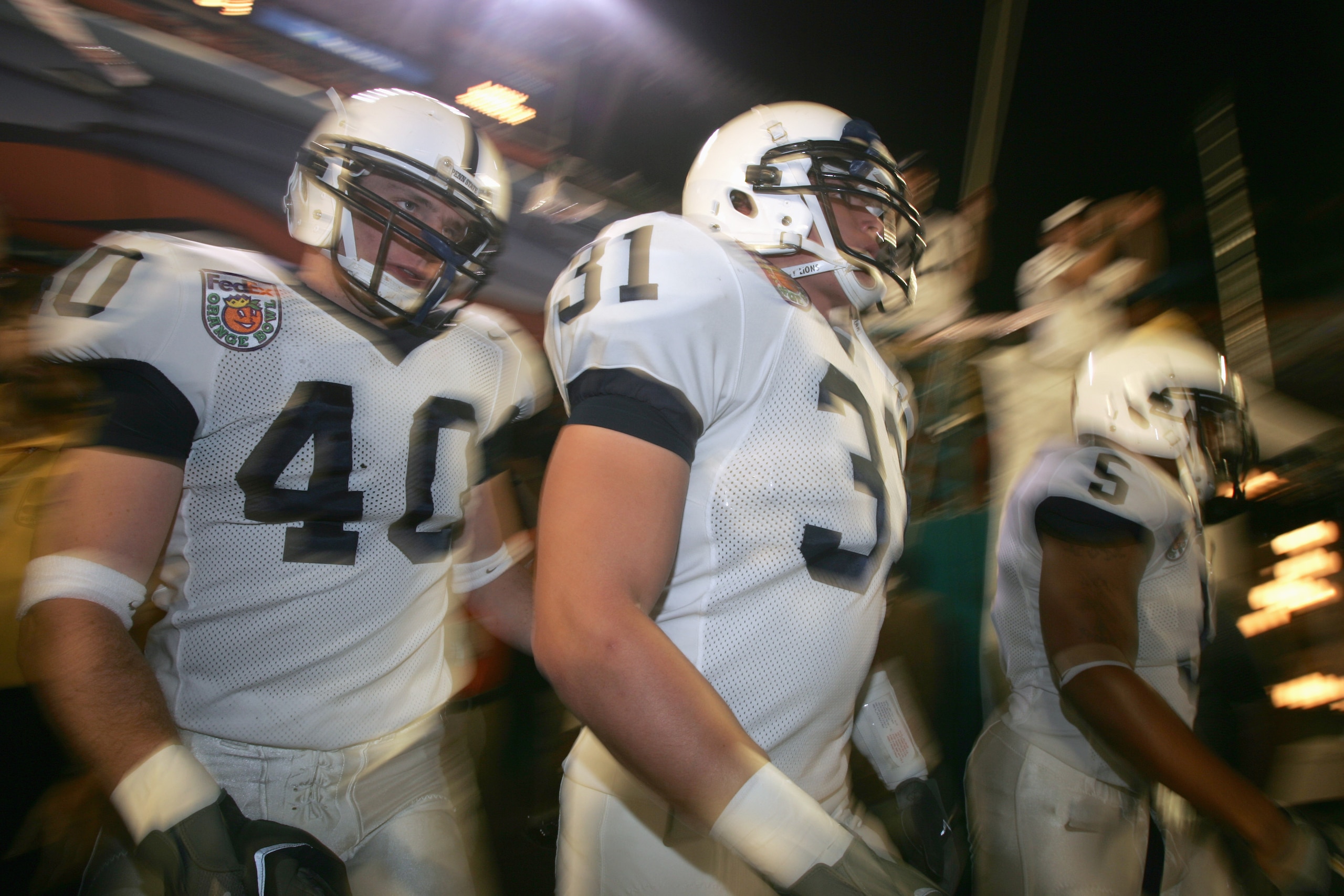 MIAMI GARDENS, FL - JANUARY 3:  Paul Posluszny #31 and Dan Connor #40 of the Penn State Nittany Lions walk out of the tunnel during the FedEx Orange Bowl against the Florida State Seminoles at Dolphins Stadium on January 3, 2005 in Miami Gardens, Florida.