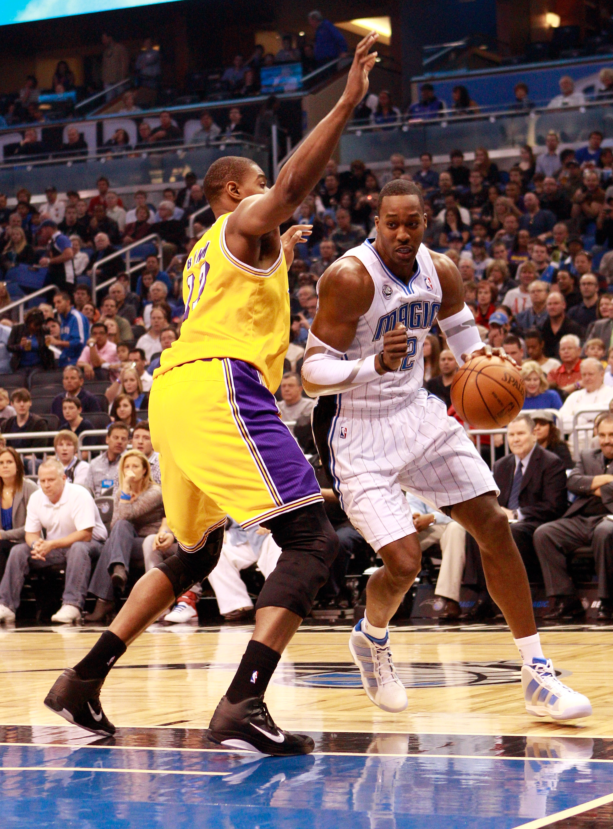 ORLANDO, FL - FEBRUARY 13:  Dwight Howard #12 of the Orlando Magic drives against Andrew Bynum #17 of the Los Angeles Lakers during the game at Amway Arena on February 13, 2011 in Orlando, Florida.  NOTE TO USER: User expressly acknowledges and agrees tha