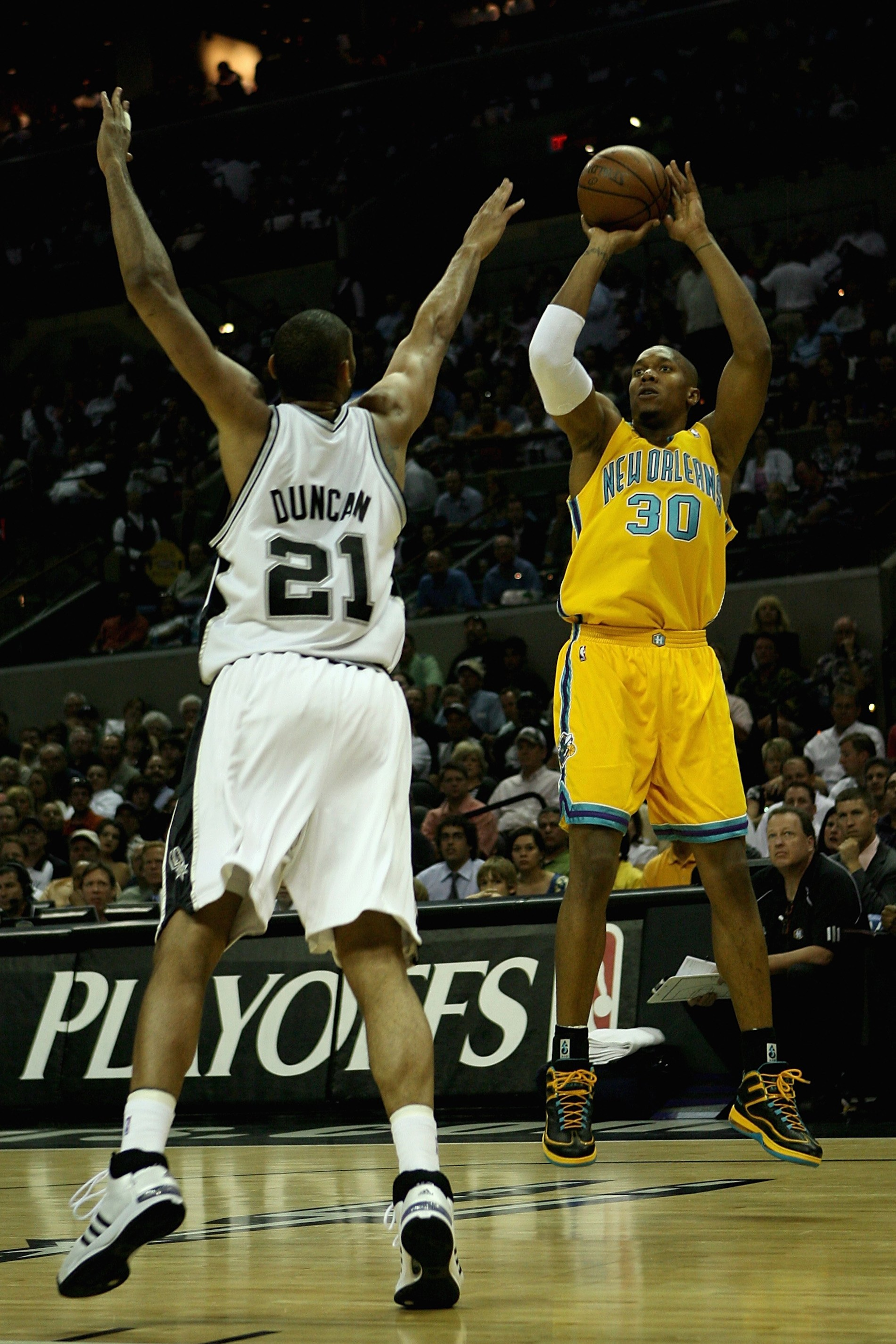 SAN ANTONIO - MAY 8:  David West #30 of the New Orleans Hornets shoots over Tim Duncan #21 of the San Antonio Spurs in Game Three of the Western Conference Semifinals during the 2008 NBA Playoffs on May 8, 2008 at the AT&T Center in San Antonio, Texas.  T