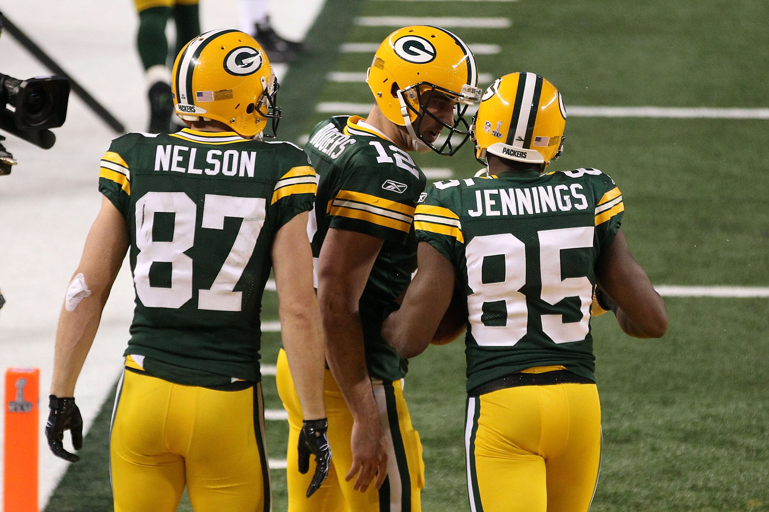 ARLINGTON, TX - FEBRUARY 06: Jordy Nelson #87, Aaron Rodgers #12 and Greg Jennings #85 of the Green Bay Packers celebrate after a 21 yard touchdown against the Pittsburgh Steelers during Super Bowl XLV at Cowboys Stadium on February 6, 2011 in Arlington,