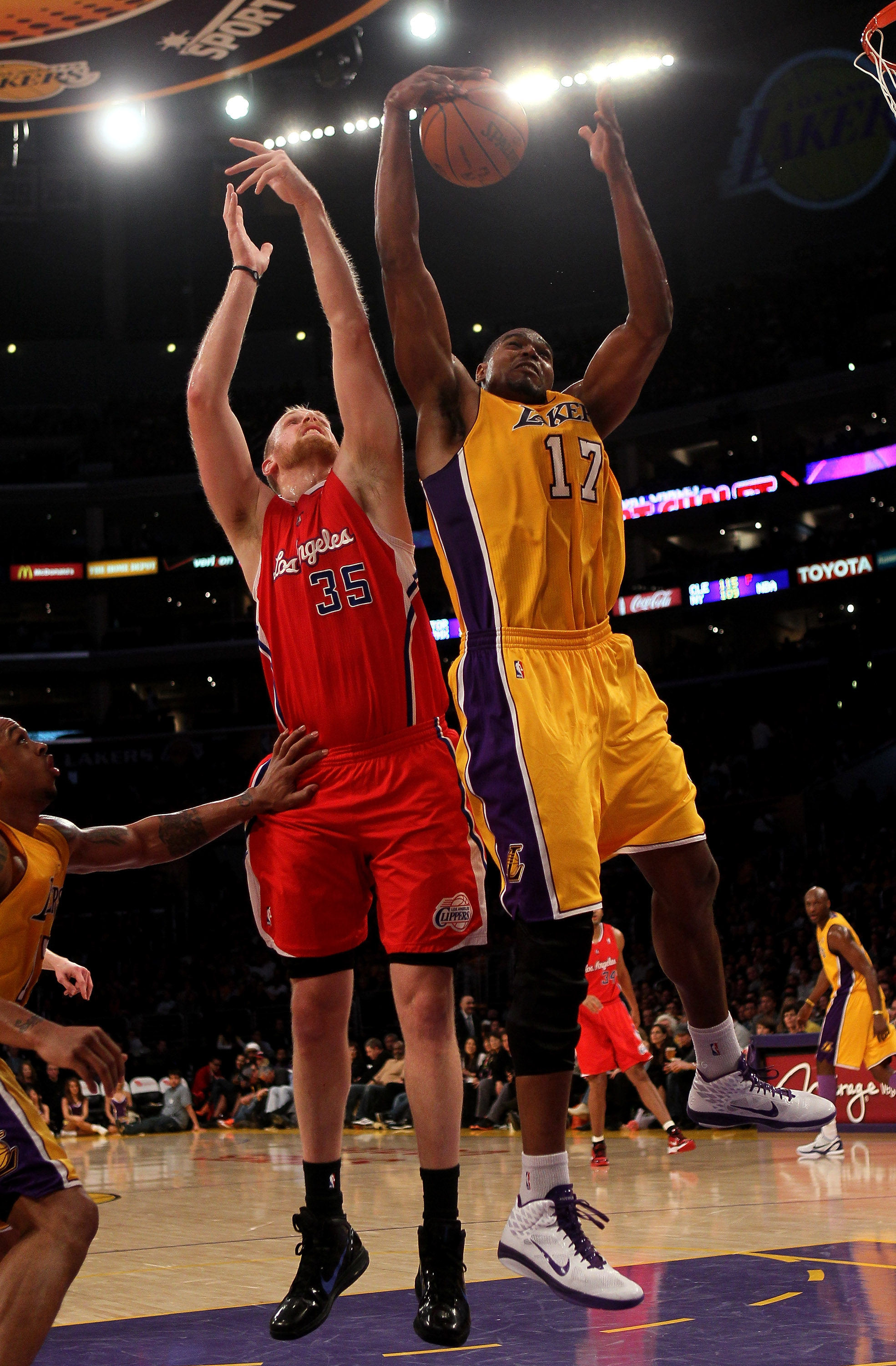 LOS ANGELES, CA - FEBRUARY 25:  Andrew Bynum #17 of the Los Angeles Lakers grabs a rebound from Chris Kaman #35 of the Los Angeles Clippers at Staples Center on February 25, 2011 in Los Angeles, California. The Lakers won 108-95.  NOTE TO USER: User expre