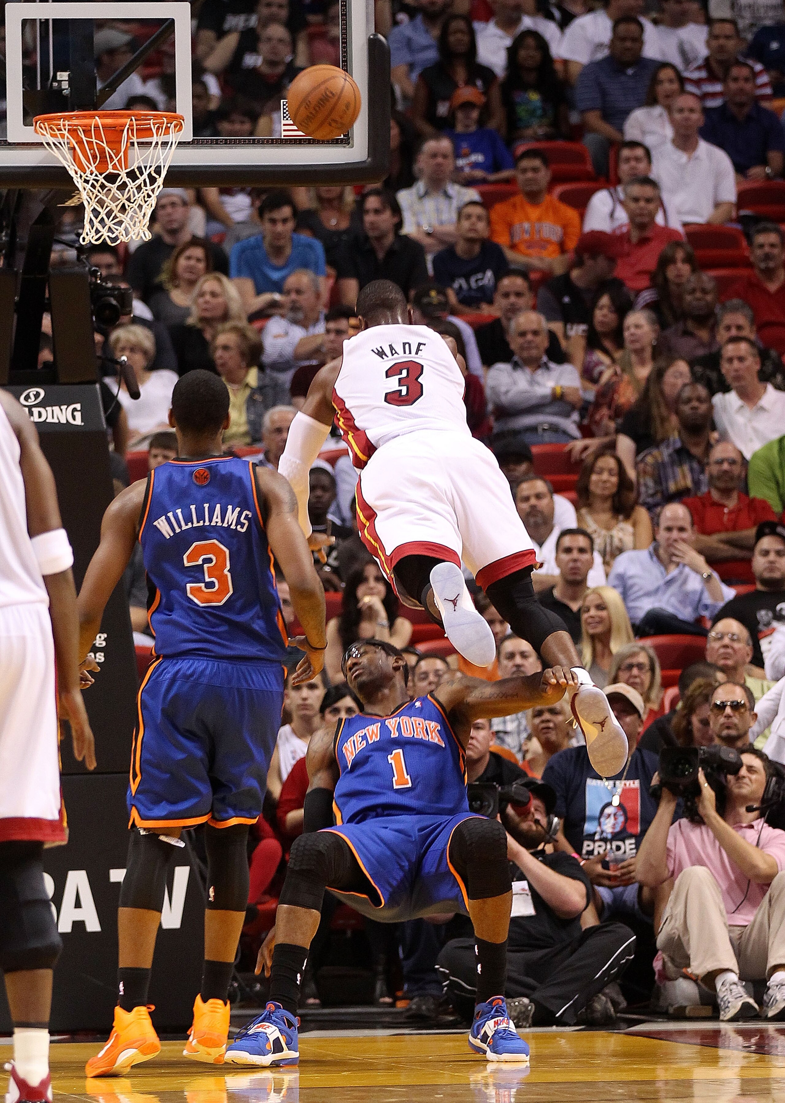 MIAMI, FL - FEBRUARY 27:  Amar'e Stoudemire #1 of the New York Knicks takes a charge against Dwyane Wade #3 of the Miami Heat during a game at American Airlines Arena on February 27, 2011 in Miami, Florida. NOTE TO USER: User expressly acknowledges and ag
