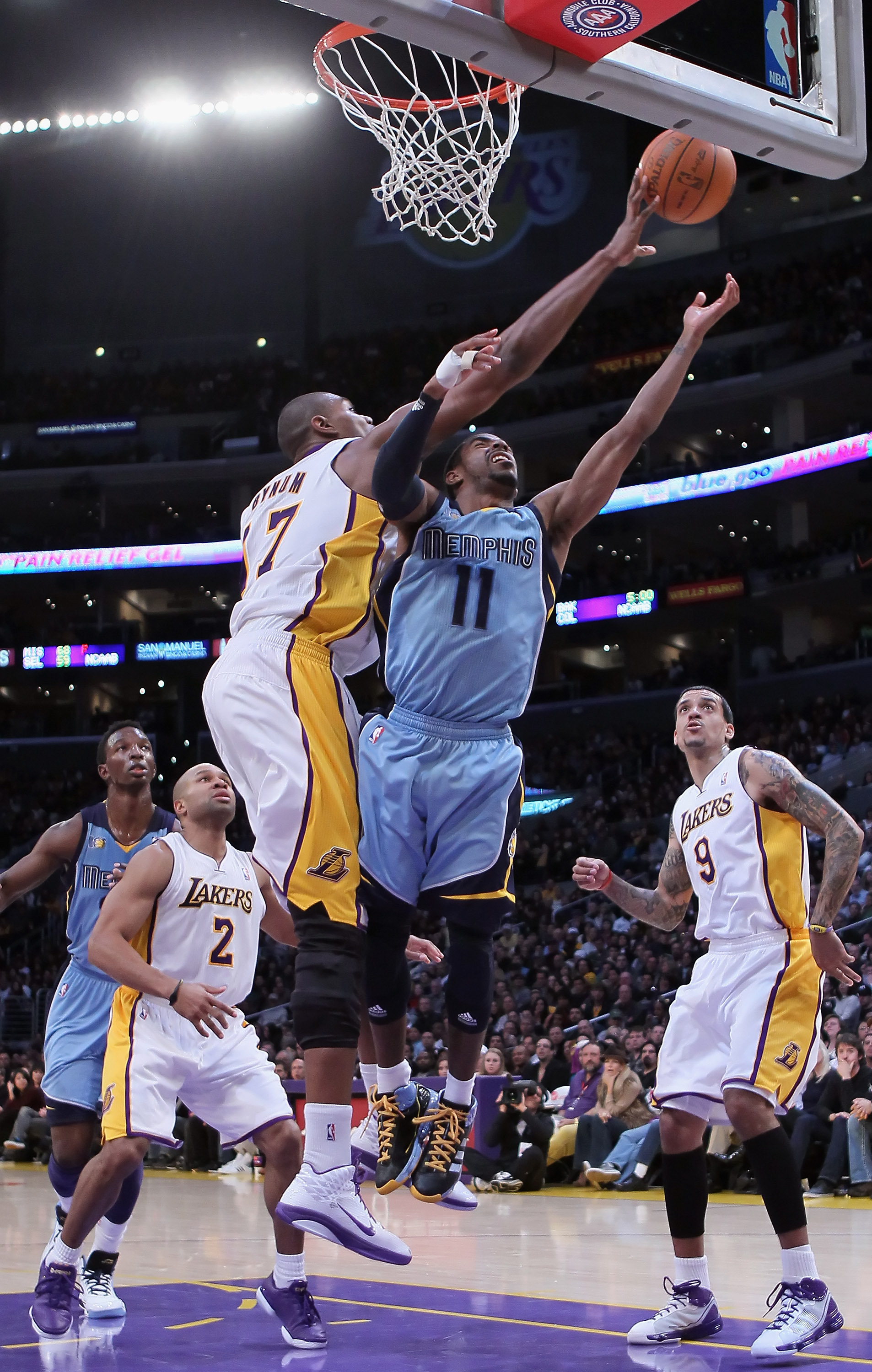 LOS ANGELES, CA - JANUARY 02:  Andrew Bynum #17 of the Los Angeles Lakers blocks a shot from Mike Conley #11 of the Memphis Grizzlies during the first half at Staples Center on January 2, 2011 in Los Angeles, California. NOTE TO USER: User expressly ackno