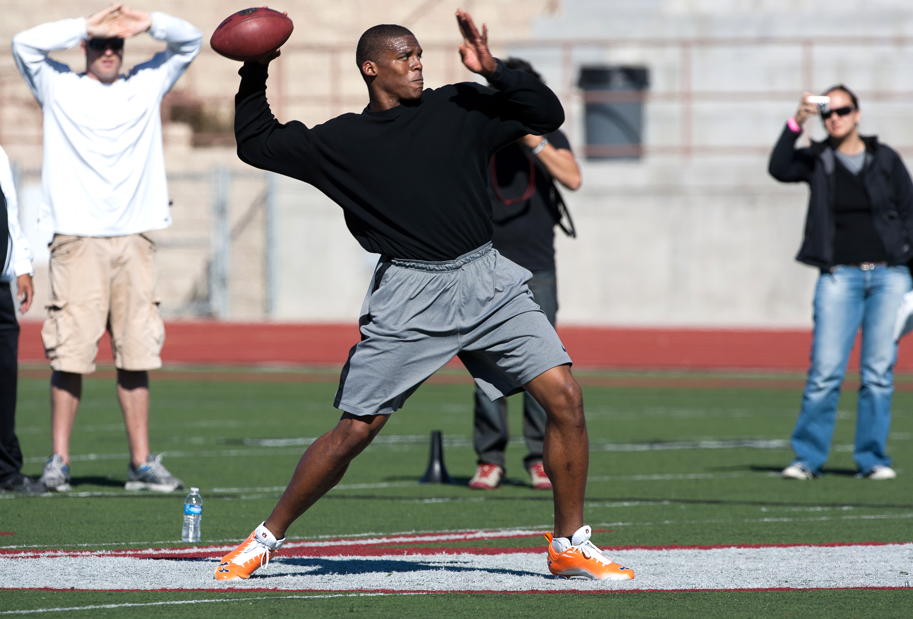 SAN DIEGO, CA - FEBRUARY 10: 2010 Heisman Trophy winning quarterback Cam Newton of Auburn throws the ball during his workout routine for the media at Cathedral High School's sports stadium on February 10, 2011 in San Diego, California. (Photo by Kent Horn