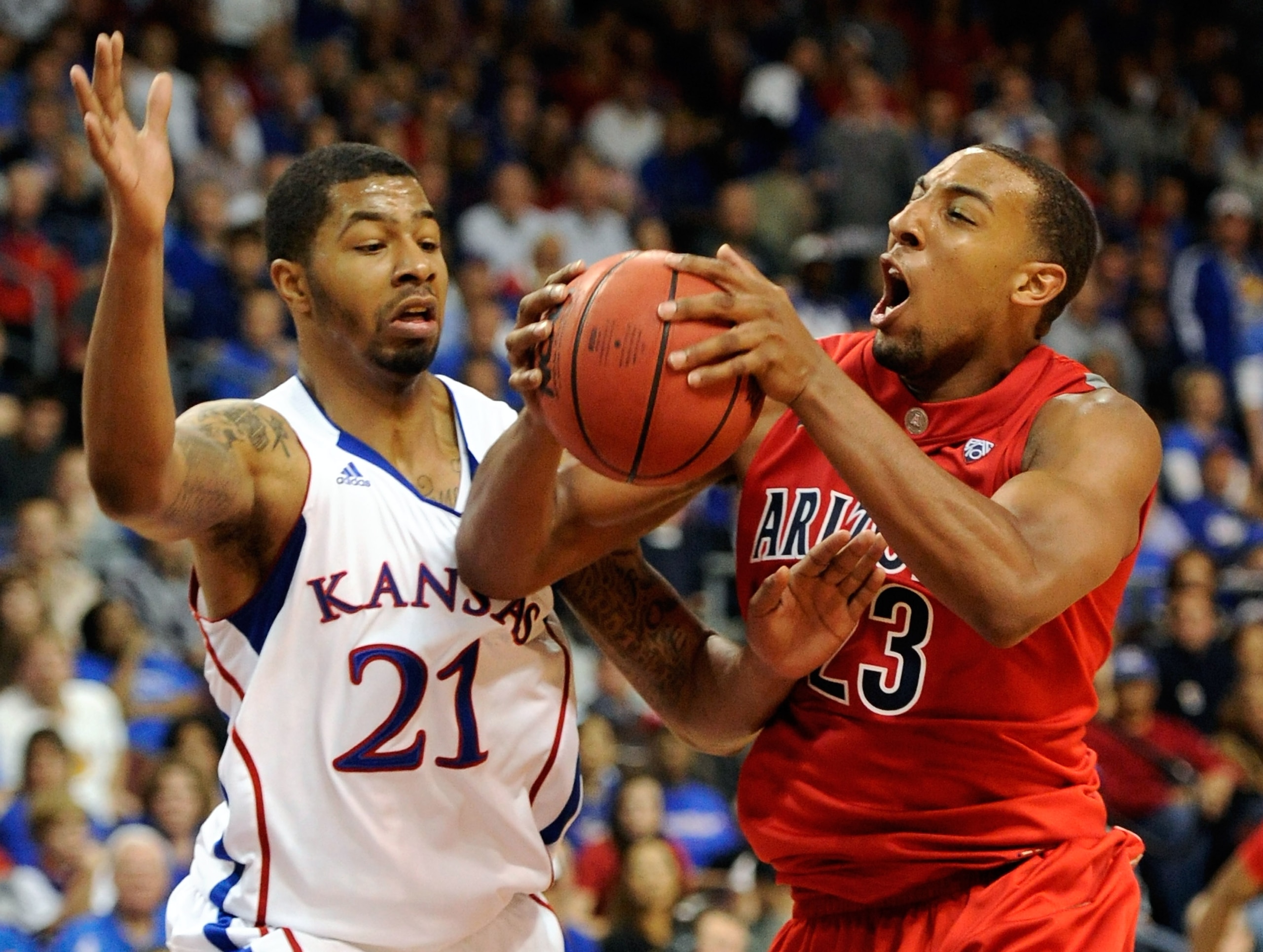 LAS VEGAS - NOVEMBER 27:  Markieff Morris #21 of the Kansas Jayhawks fouls Derrick Williams #23 of the Arizona Wildcats during the championship game of the Las Vegas Invitational at The Orleans Arena November 27, 2010 in Las Vegas, Nevada. Kansas won 87-7
