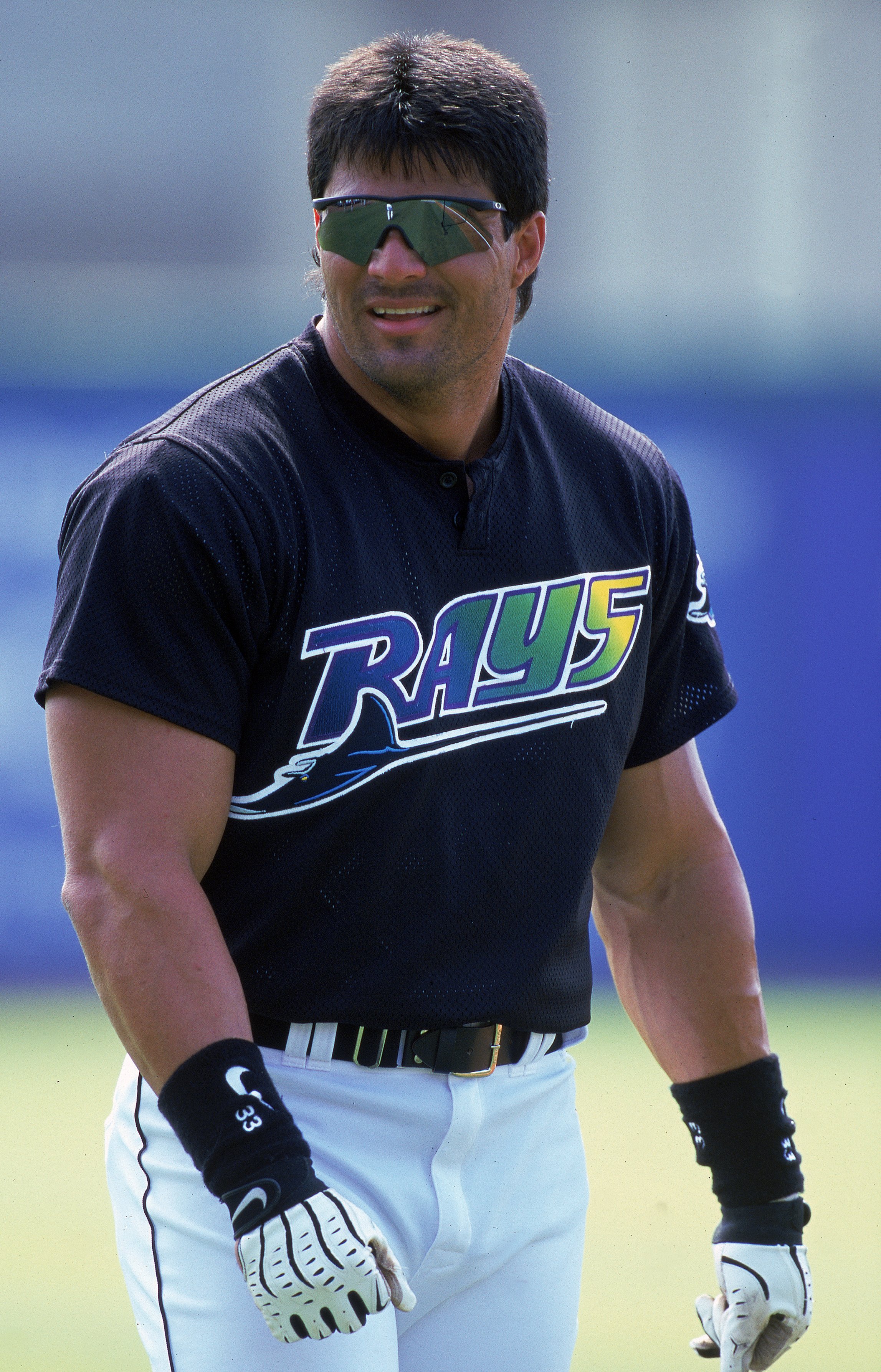 8 Mar 2000: Jose Canseco #33 of the  Tampa Bay Devil Rays smiles as he walks on the field during the Spring Training Game against the Philadelphia Phillies at Florida Power Park in St. Petersburgh, Florida. Mandatory Credit: Scott Halleran  /Allsport