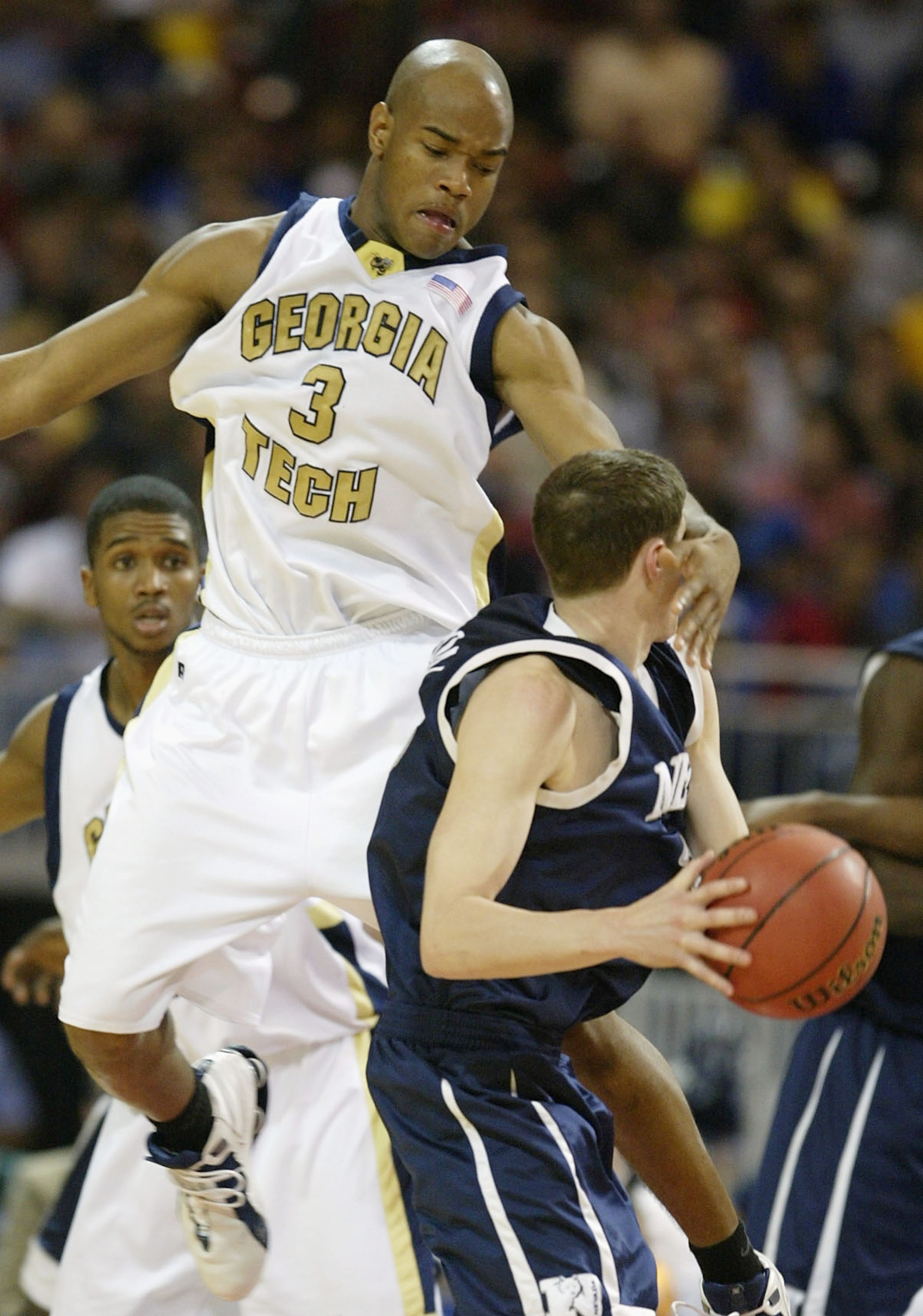 St. LOUIS - MARCH 26: Jarret Jack #3 of the Georgia Tech Yellow Jackets fouls Nick Fazekas #22 of the Nevada Wolfpack during the third round game of the NCAA Division I Men's Basketball Tournament at the Edward Jones Dome on March 26, 2004 in St. Louis, M