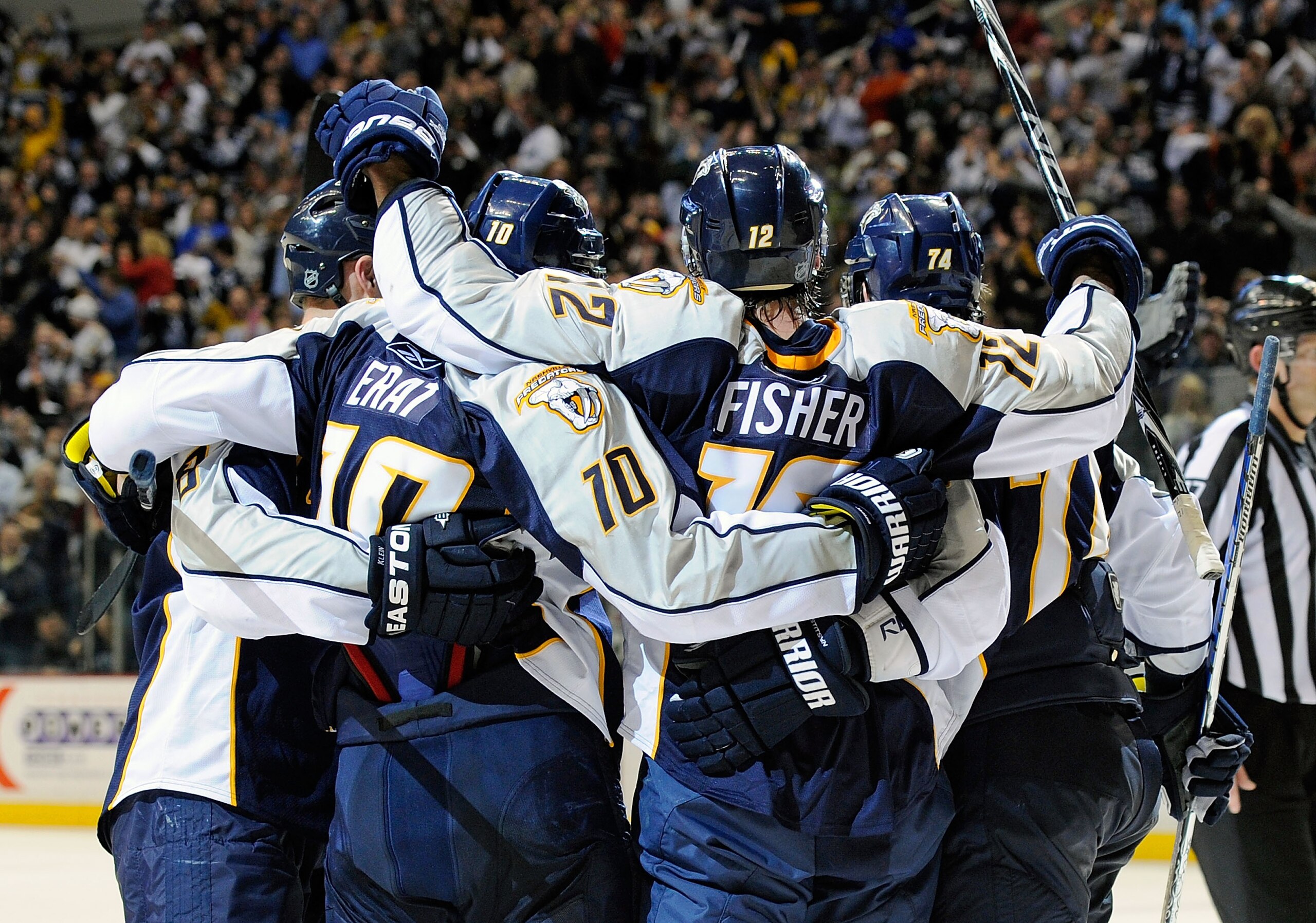 NASHVILLE, TN - FEBRUARY 17: Mike Fisher #12 of the Nashville Predators is congratulated by teammates after scoring a goal against the Vancouver Canucks on February 17, 2011 at the Bridgestone Arena in Nashville, Tennessee. (Photo by Frederick Breedon/G NASHVILLE, TN - FEBRUARY 17: Mike Fisher #12 of the Nashville Predators is congratulated by teammates after scoring a goal against the Vancouver Canucks on February 17, 2011 at the Bridgestone Arena in Nashville, Tennessee. (Photo by Frederick Breedon/G