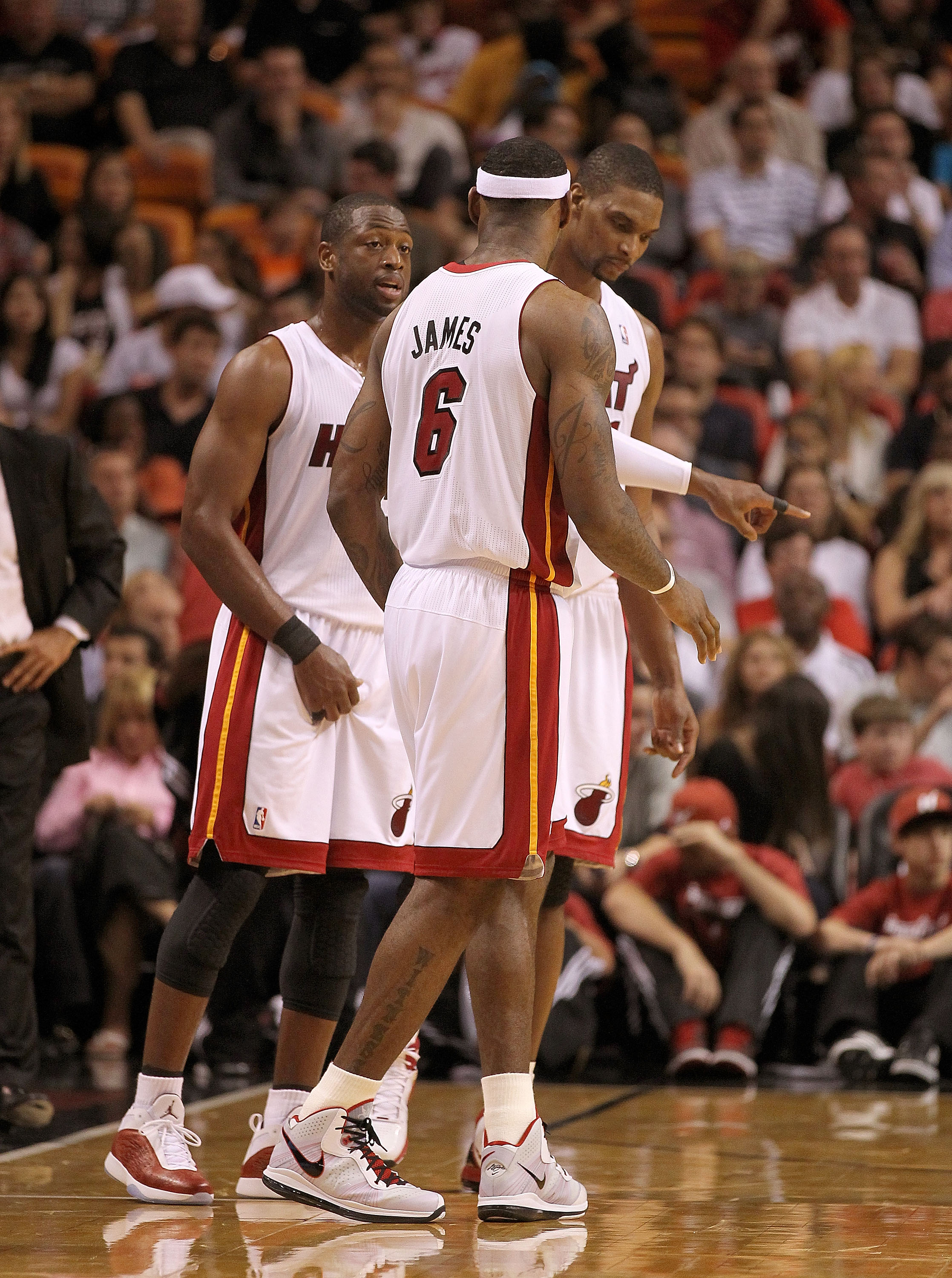 MIAMI, FL - FEBRUARY 25:  LeBron James #6, Dwyane Wade #3, and Chris Bosh #1 of the Miami Heat talk during a game against the Washington Wizards at American Airlines Arena on February 25, 2011 in Miami, Florida. NOTE TO USER: User expressly acknowledges a