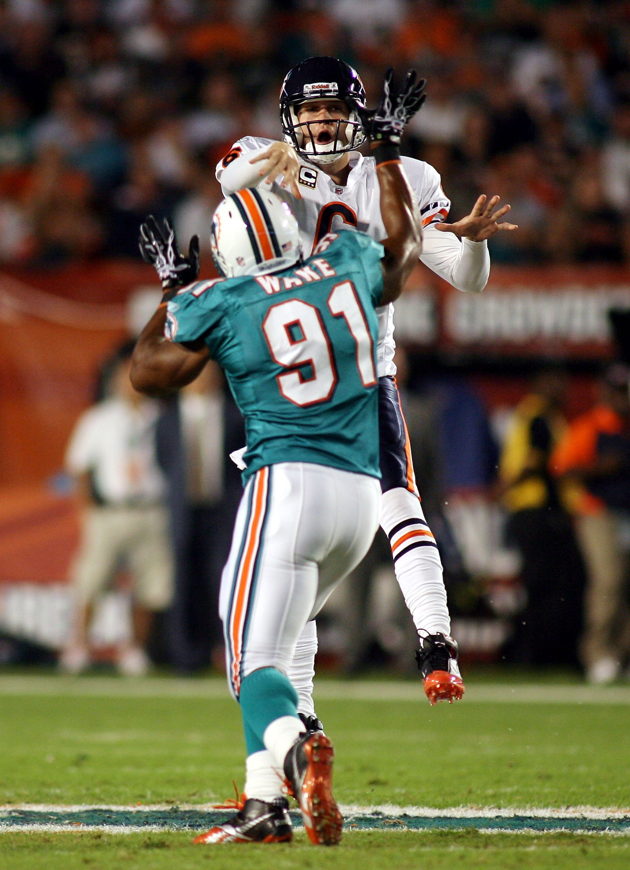 MIAMI - NOVEMBER 18:  Quarterback Jay Cutler #6 of the Chicago Bears is preasured by linebacker Cameron wake #91 of the Miami Dolphins at Sun Life Stadium on November 18, 2010 in Miami, Florida.  (Photo by Marc Serota/Getty Images)
