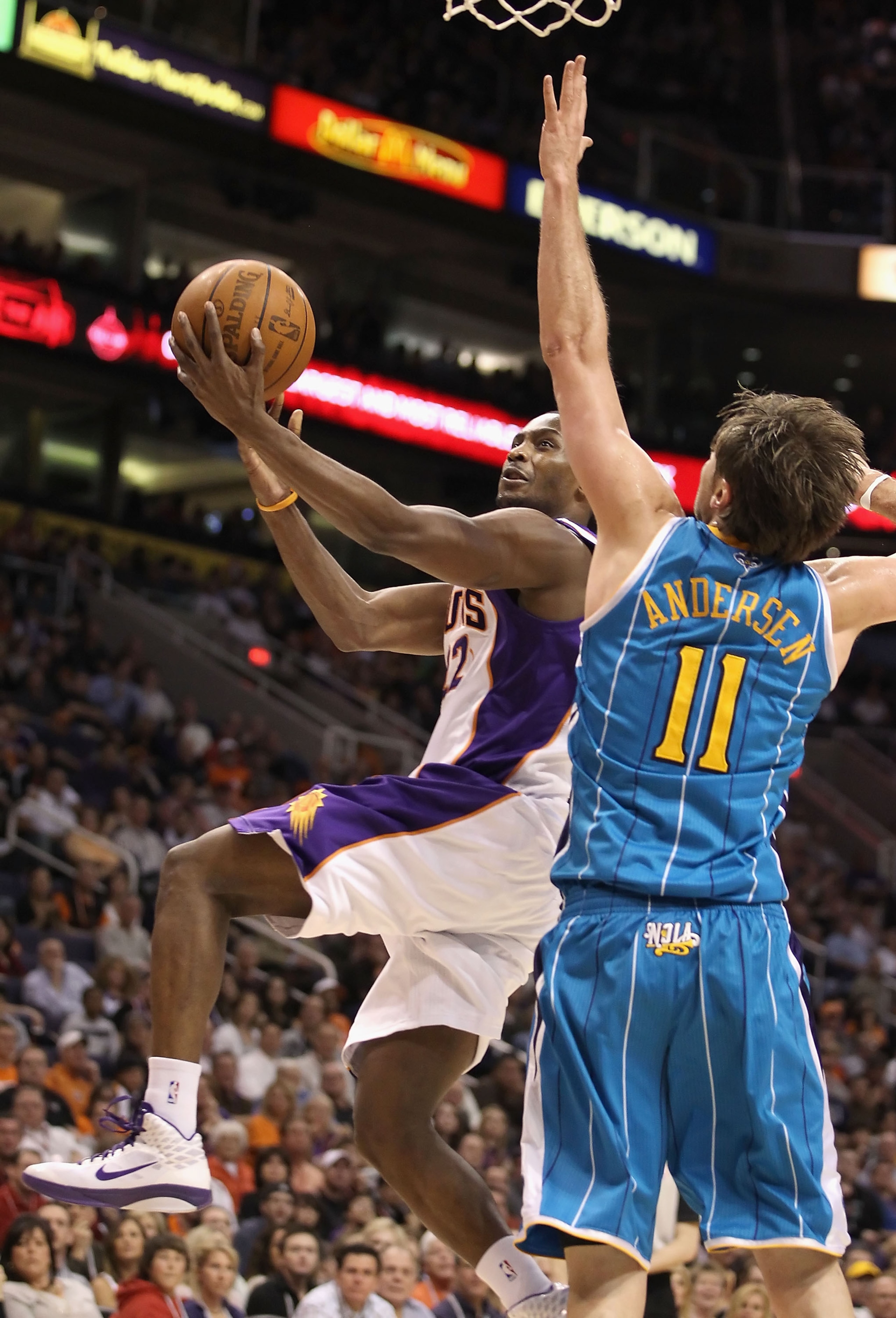 PHOENIX, AZ - JANUARY 30:  Zabian Dowdell #22 of the Phoenix Suns drives the ball to the basket past David Andersen #11 of the New Orleans Hornets during the NBA game at US Airways Center on January 30, 2011 in Phoenix, Arizona.  The Suns defeated the Hor