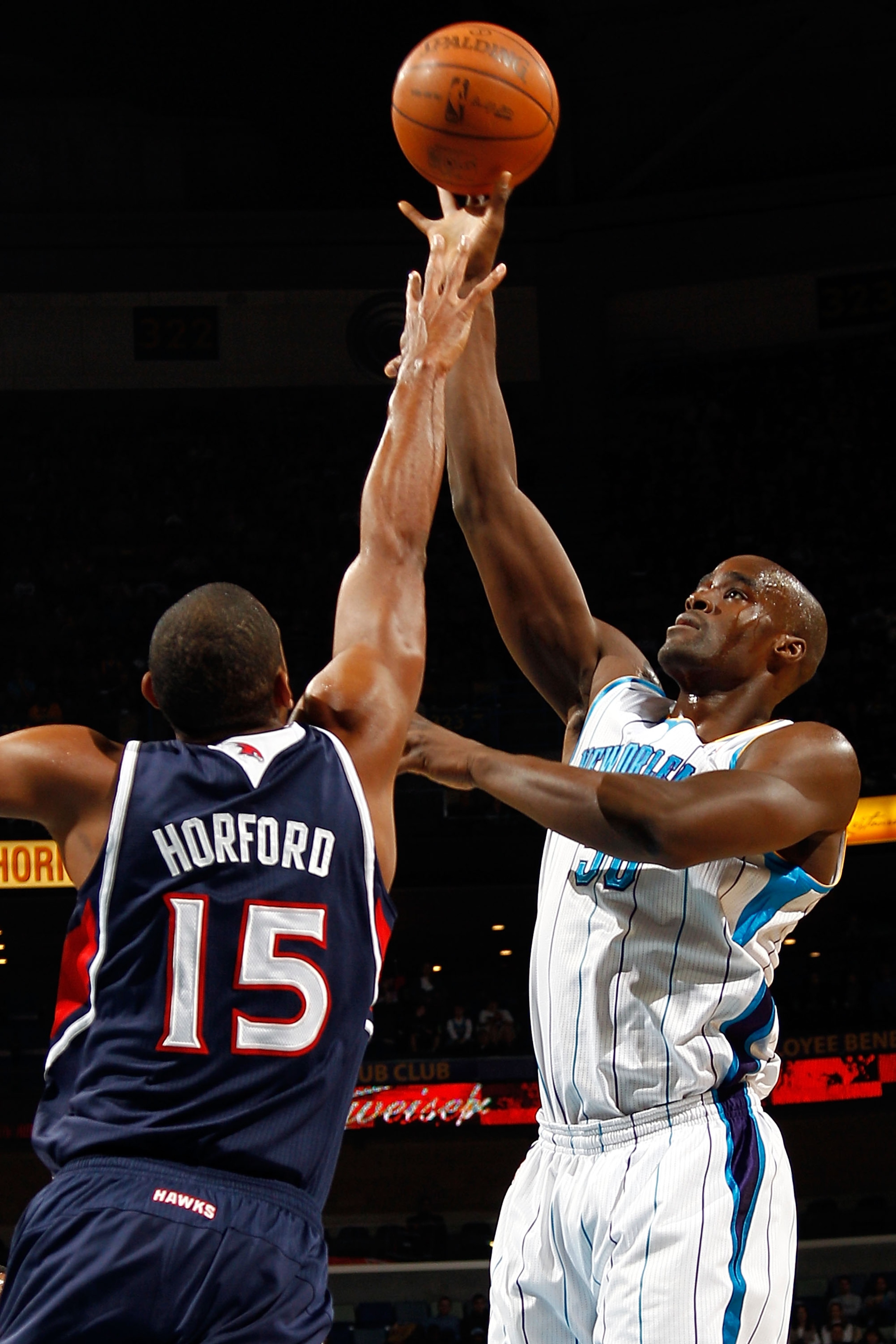 NEW ORLEANS, LA - DECEMBER 26:  Emeka Okafor #50 of the New Orleans Hornets shoots the ball over AL Horford #15 of the Atlanta Hawks at the New Orleans Arena on December 26, 2010 in New Orleans, Louisiana.  NOTE TO USER: User expressly acknowledges and ag