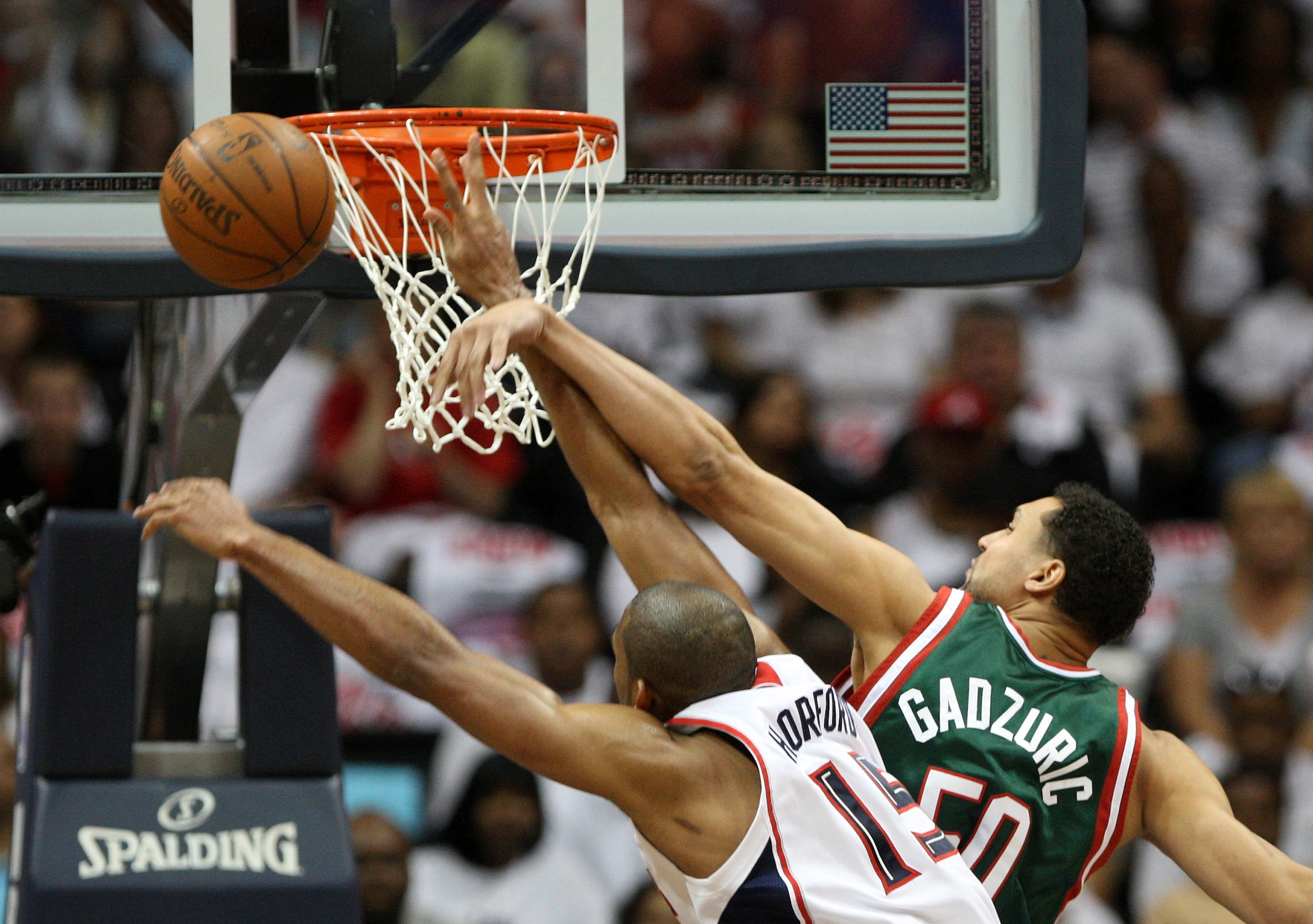 ATLANTA - MAY 2:  Center Dan Gadzuric #50 of the Milwaukee Bucks fouls center Al Horford #15 of the Atlanta Hawks during Horford's shot attempt during Game Seven of the Eastern Conference Quarterfinals between the Milwaukee Bucks and the Atlanta Hawks dur