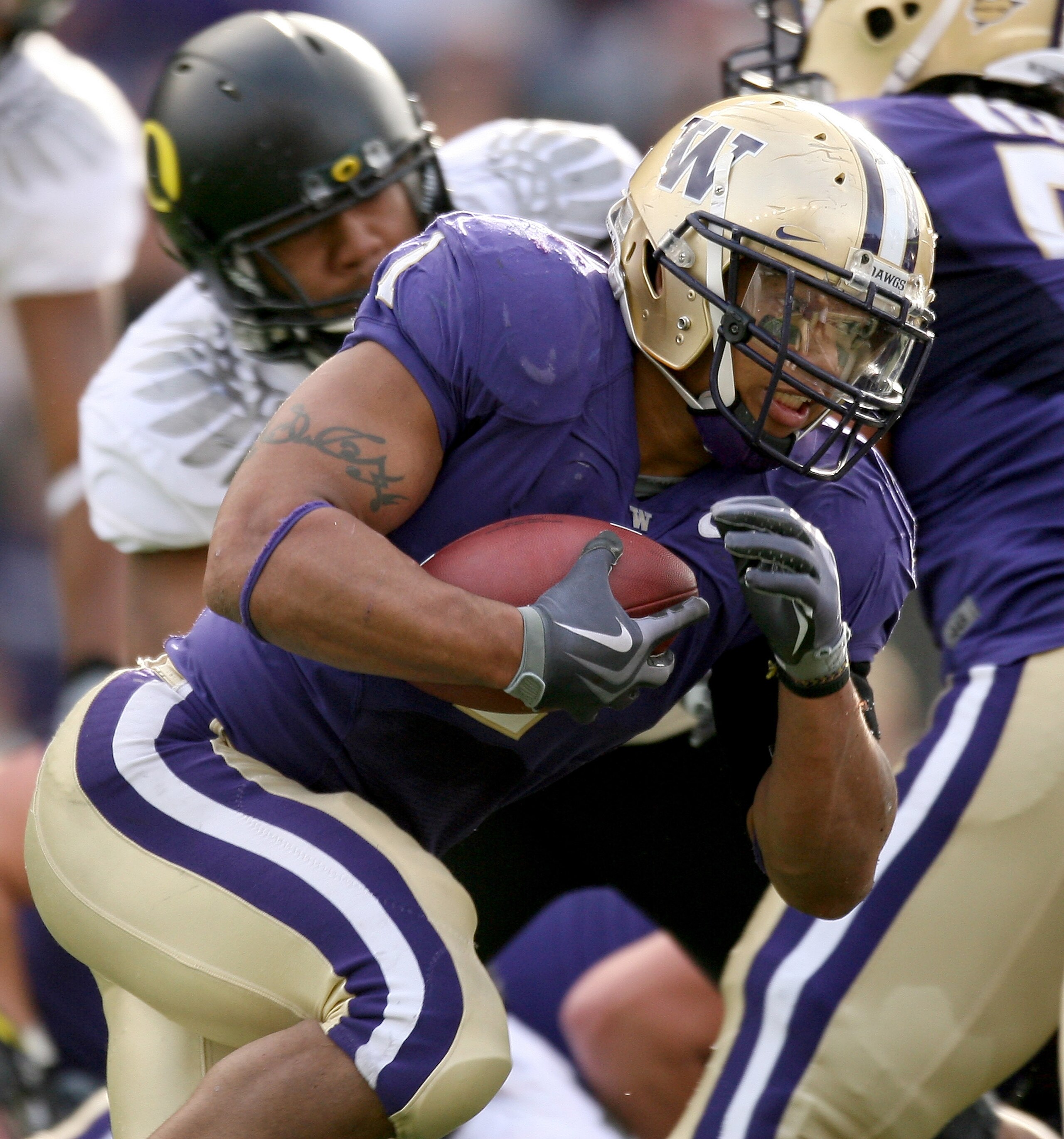 SEATTLE - OCTOBER 24:  Running back Chris Polk #1 of the Washington Huskies rushes against the Oregon Ducks on October 24, 2009 at Husky Stadium in Seattle, Washington. The Ducks defeated the Huskies 43-19. (Photo by Otto Greule Jr/Getty Images)