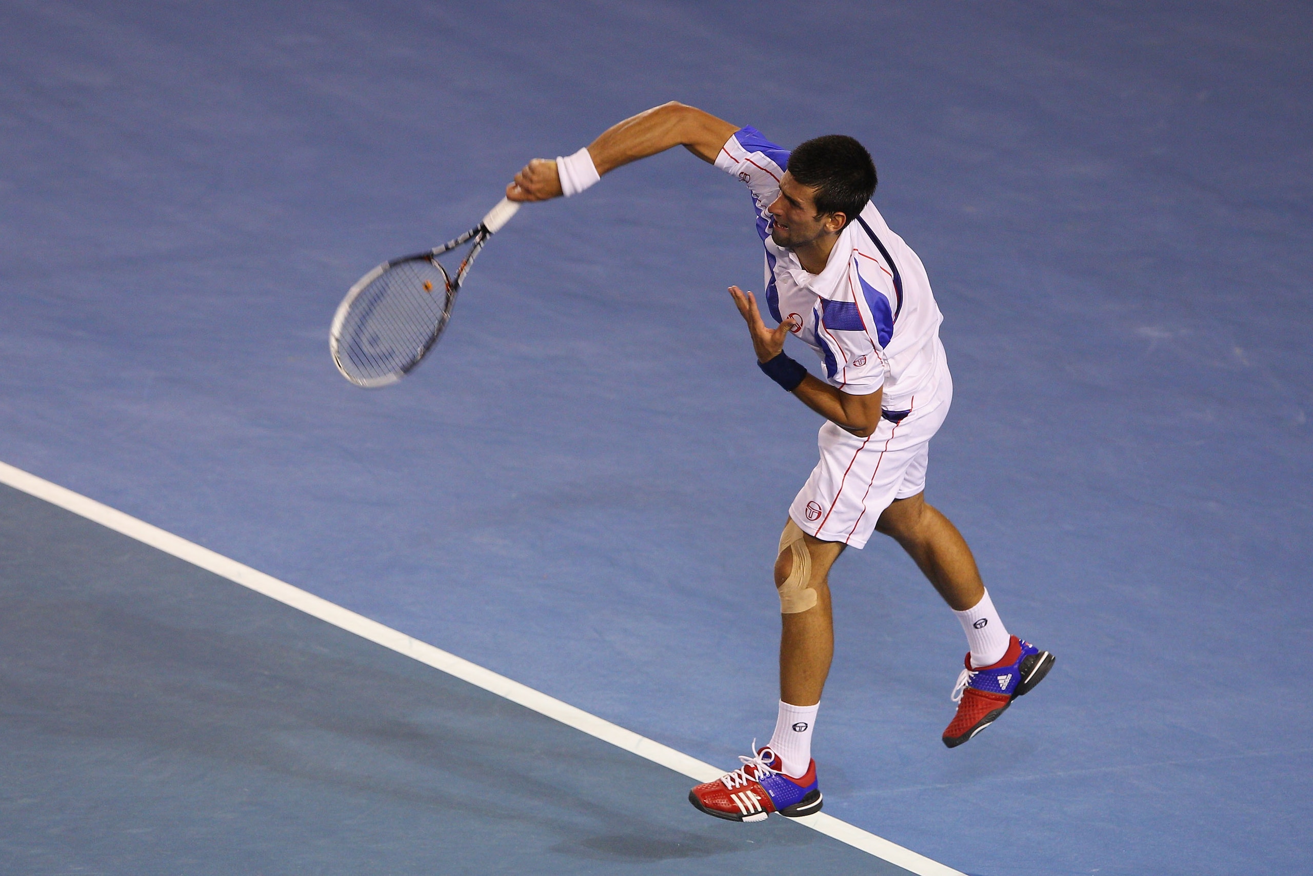 MELBOURNE, AUSTRALIA - JANUARY 30:  Novak Djokovic of Serbia serves in his men's final match against Andy Murray of Great Britain during day fourteen of the 2011 Australian Open at Melbourne Park on January 30, 2011 in Melbourne, Australia.  (Photo by Cam