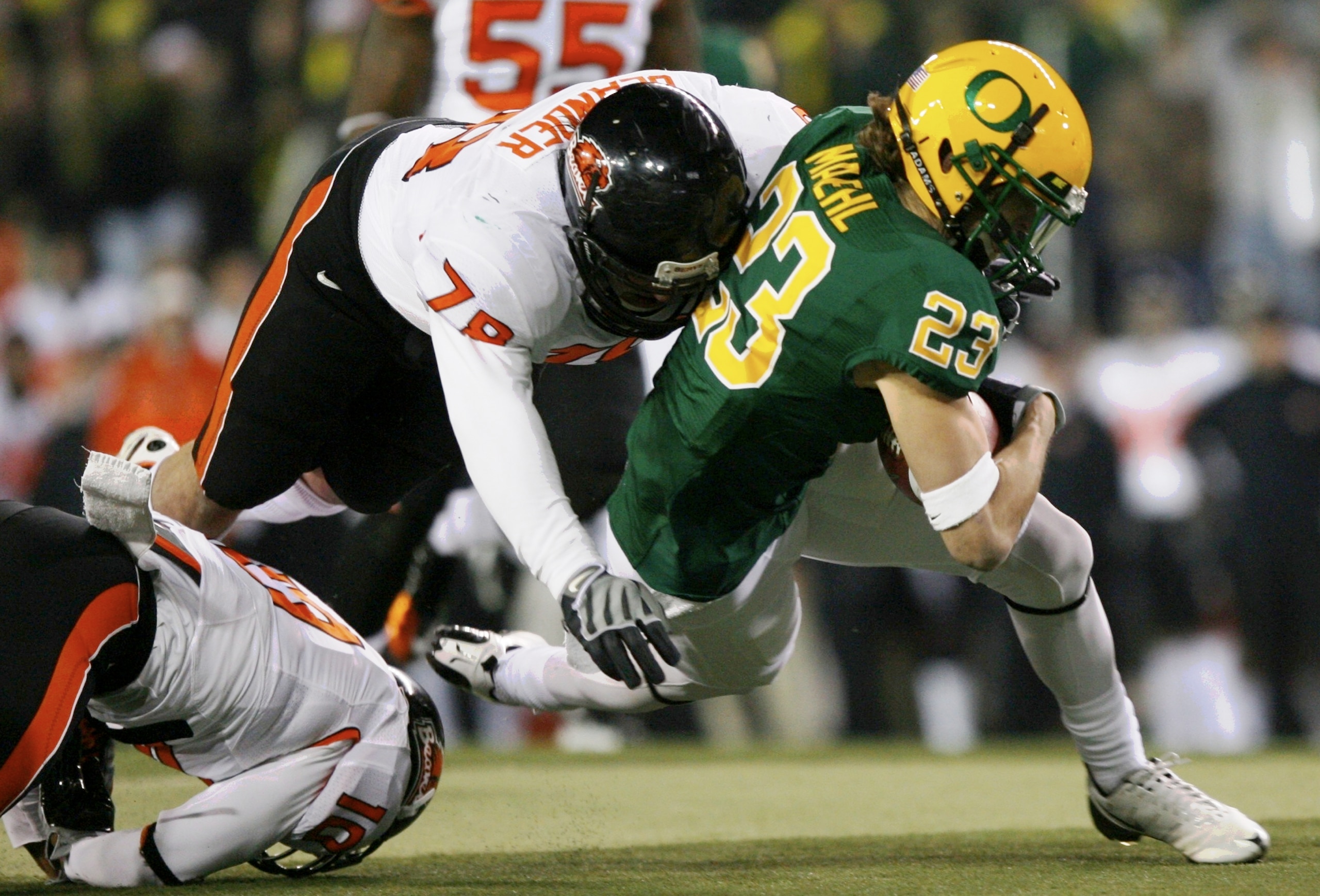 EUGENE,OR - DECEMBER 03:  Brennan Olander #78 of the Oregon State Beavers tackles Jeff Maehl #23 of the Oregon Ducks during the second quarter of the game at Autzen Stadium on December 3, 2009 in Eugene, Oregon.  (Photo by Tom Hauck/Getty Images)