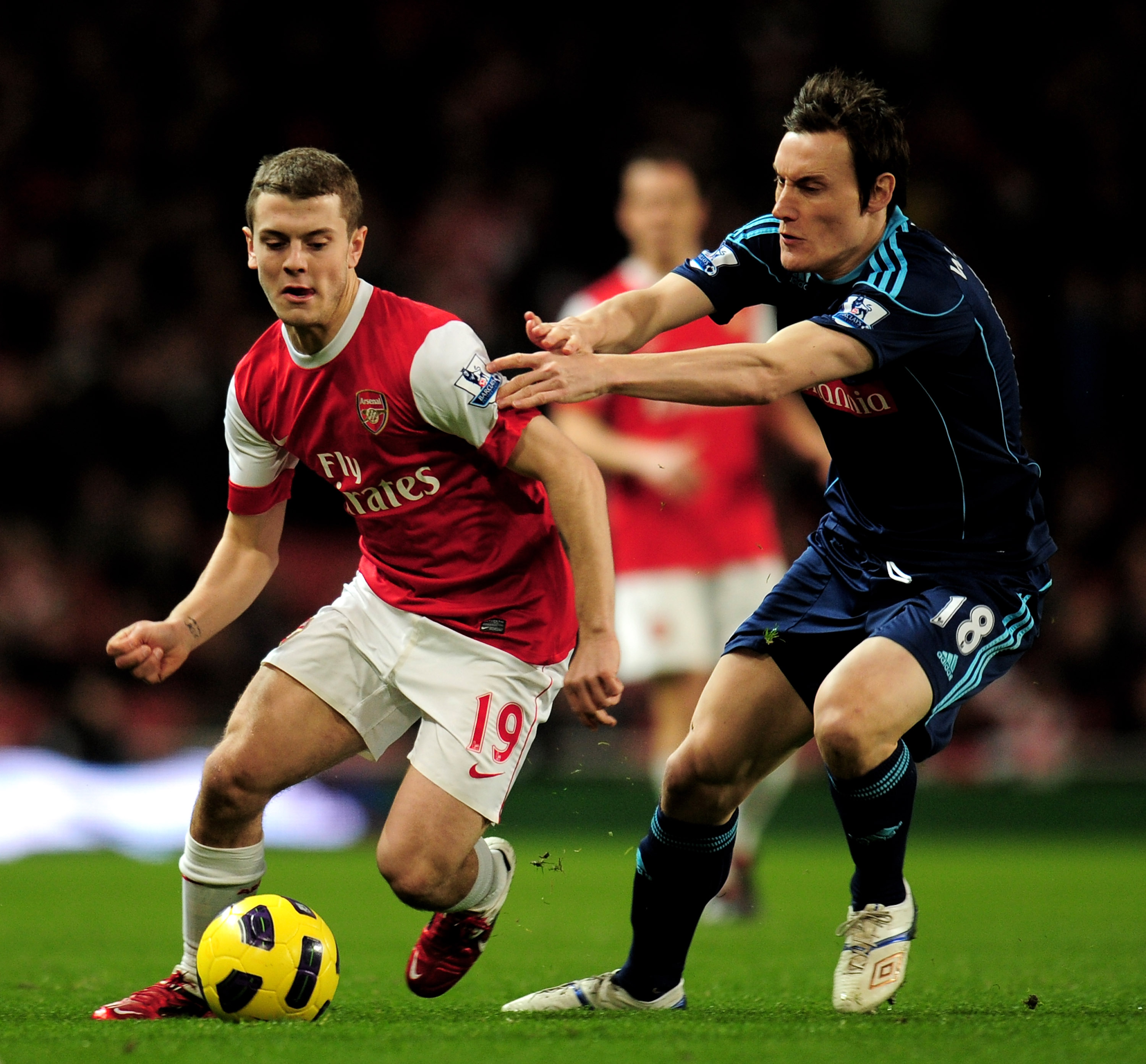 LONDON, ENGLAND - FEBRUARY 23:  Jack Wilshere (L) of Arsenal is challenged by Dean Whitehead of Stoke during the Barclays Premier League match between Arsenal and Stoke City at the Emirates Stadium on February 23, 2011 in London, England.  (Photo by Shaun