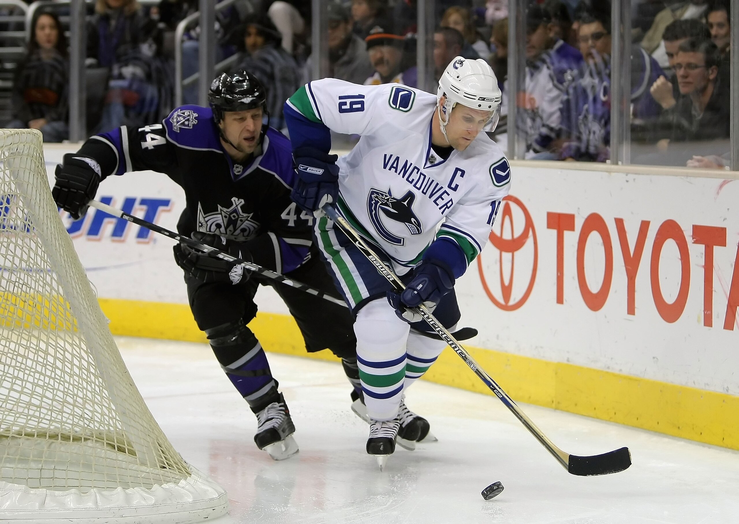 LOS ANGELES, CA - DECEMBER 10:  Markus Naslund #19 of the Vancouver Canucks skates with the puck past Jaroslav Modry #44 of the Los Angeles Kings during the NHL game at Staples Center on December 10, 2007 in Los Angeles, California. The Kings defeated the