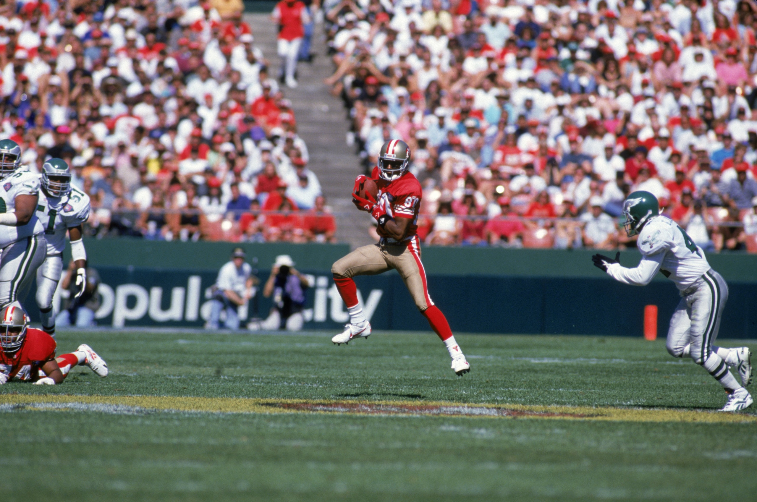 SAN FRANCISCO - OCTOBER 2:  Wide receiver Jerry Rice #80 of the San Francisco 49ers finds room to run against Philadelphia Eagles defense during a game at Candlestick Park on October 2, 1994 in San Francisco, California.  The Eagles won 40-8.  (Photo by G