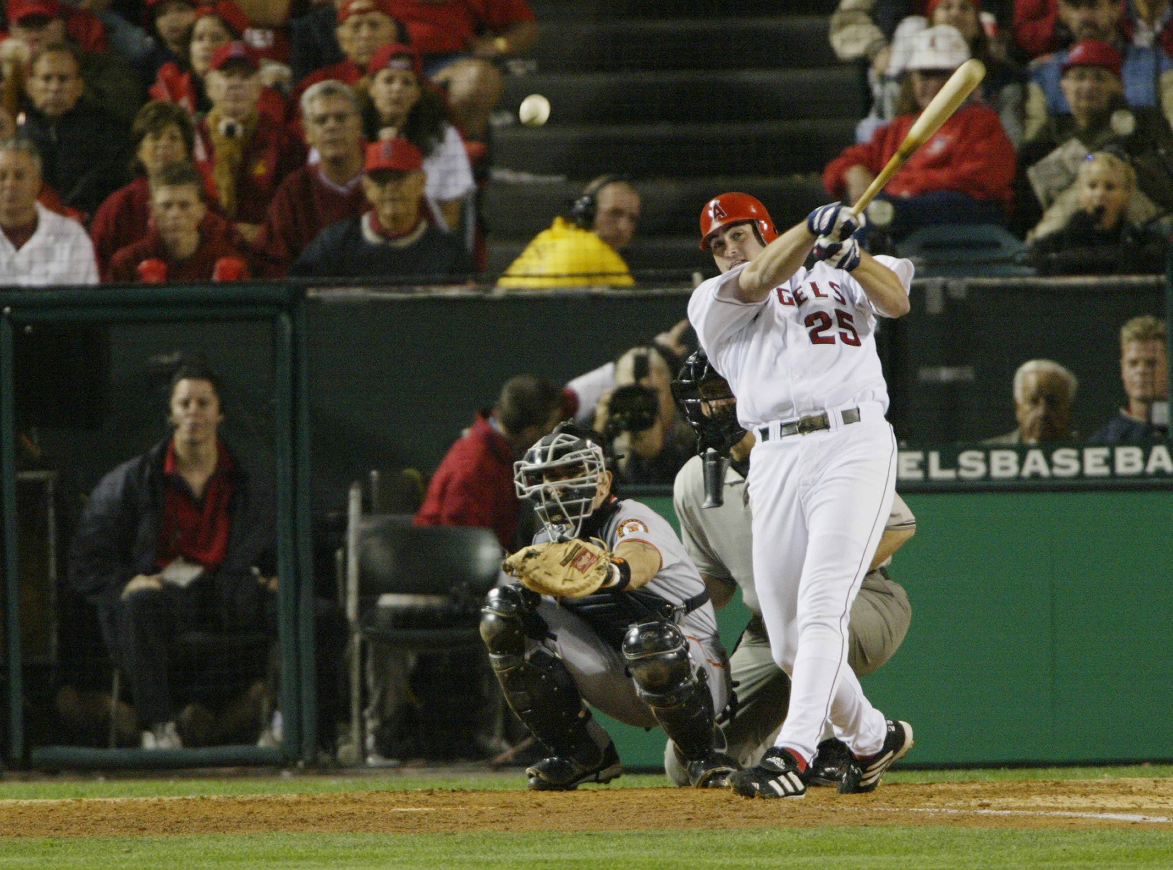 ANAHEIM, CA - OCTOBER 26:  Troy Glaus #25 of the Anaheim Angels hits the ball against the San Francisco Giants during game six of the World Series on October 26, 2002 at Edison Field in Anaheim, California. The Angels defeated the Giants 6-5. (Photo by Je