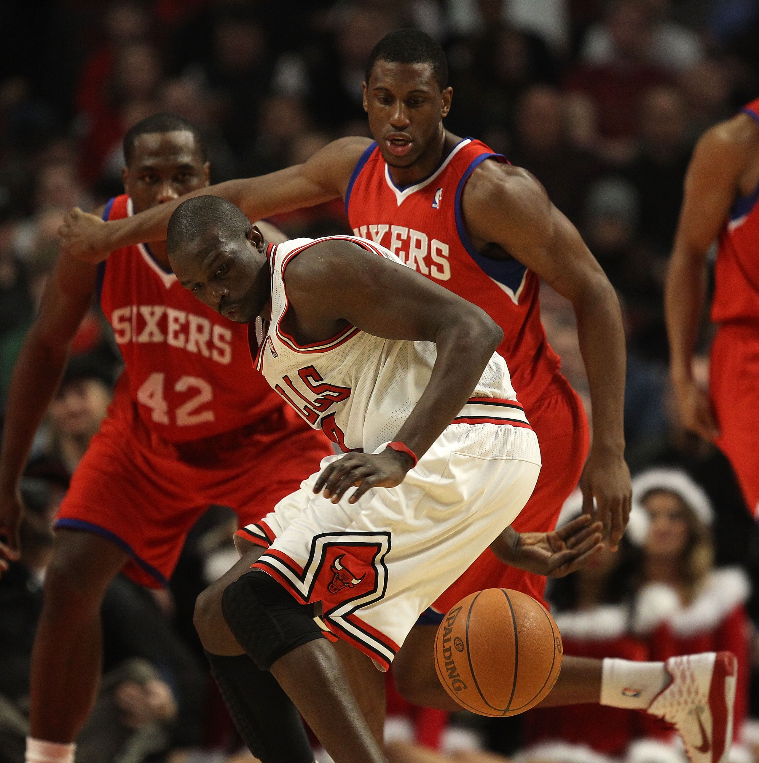 CHICAGO, IL - DECEMBER 21: Luol Deng #9 of the Chicago Bulls looses control of the ball under pressure from Louis Williams #23 of the Philadelphia 76ers at the United Center on December 21, 2010 in Chicago, Illinois. NOTE TO USER: User expressly acknowled