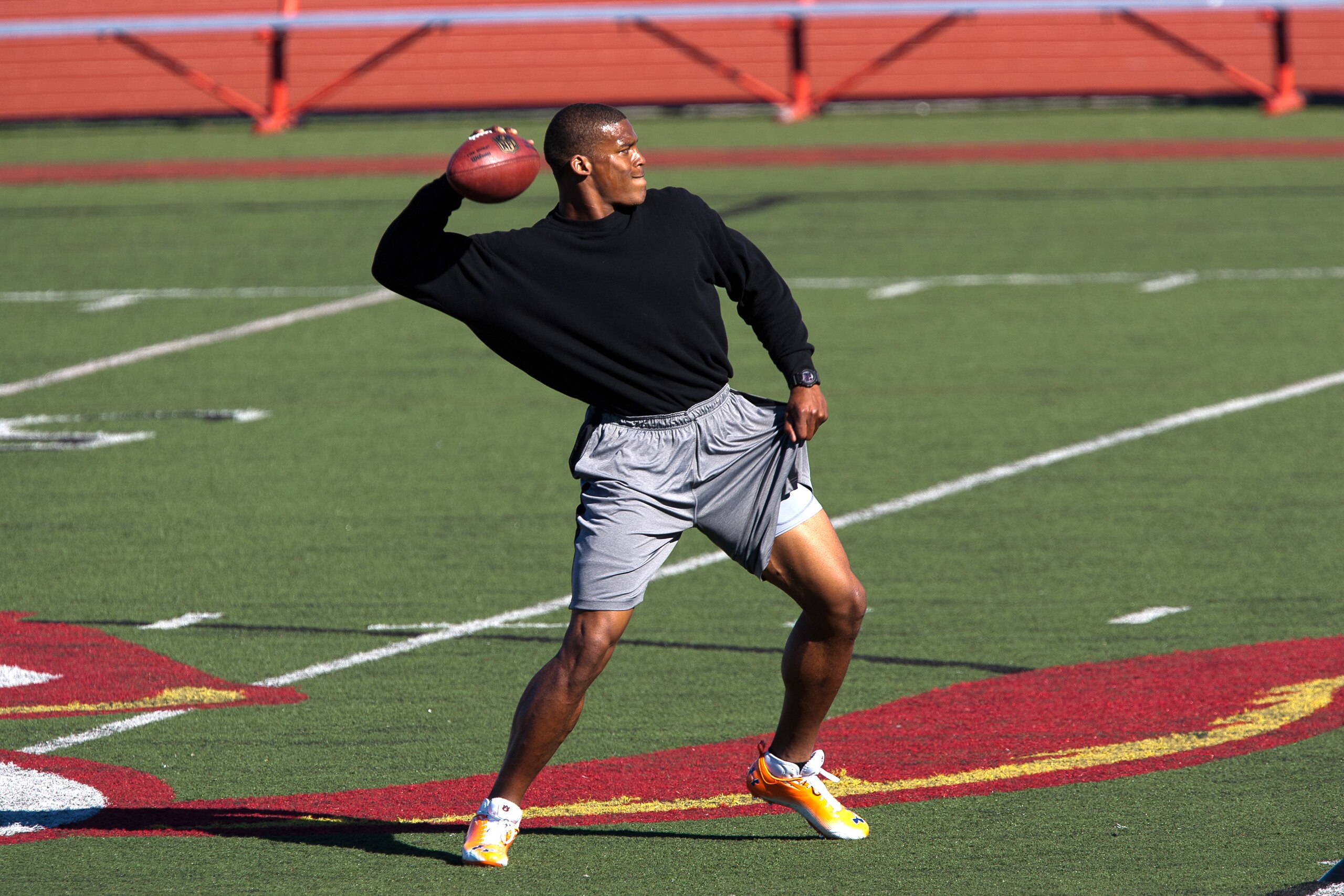 SAN DIEGO, CA - FEBRUARY 10:  2010 Heisman Trophy winning quarterback Cam Newton of the Auburn Tigers throws the ball during his workout routine for the media at Cathedral High School's sports stadium on February 10, 2011 in San Diego, California.  (Photo
