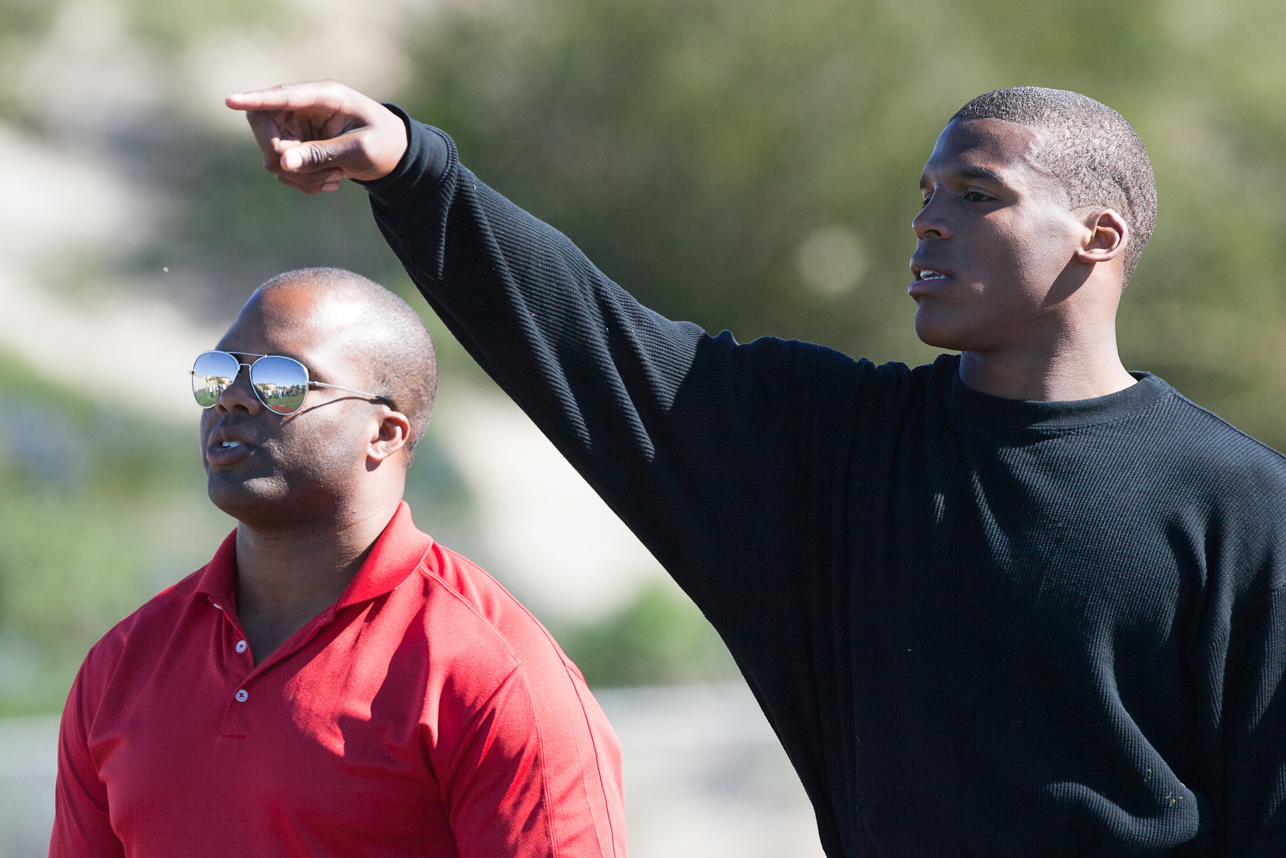 SAN DIEGO, CA - FEBRUARY 10:  2010 Heisman Trophy winning quarterback Cam Newton of the Auburn Tigers goes through his workout routine with trainer George Whitfield for the media at Cathedral High School's sports stadium on February 10, 2011 in San Diego,