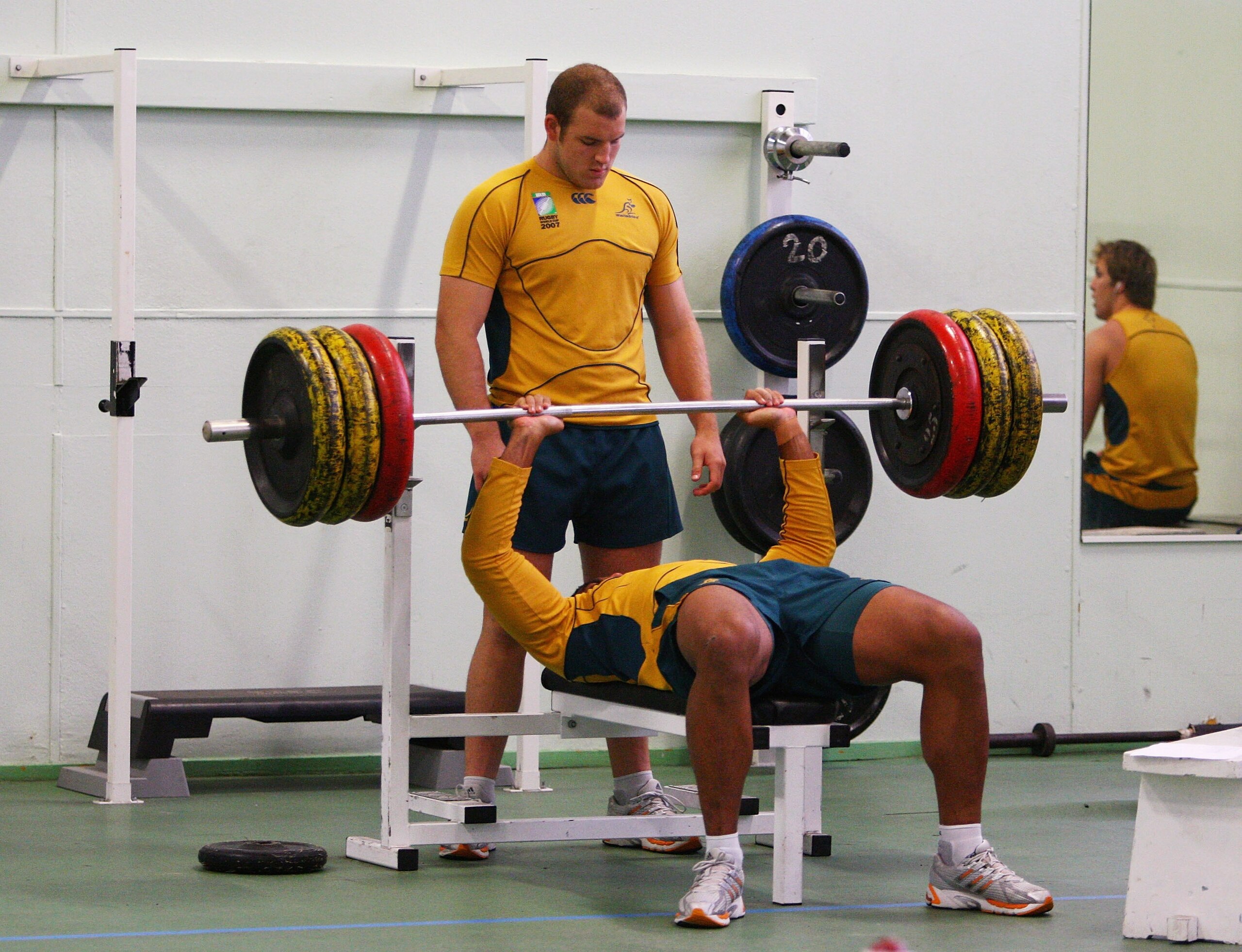 BORDEAUX, FRANCE - OCTOBER 01:  Stephen Moore of the Wallabies spots team mate Wycliff Palu as he bench presses during an Australian Wallabies strength training session at the Colombier Gymnasium October 1, 2007 in Bordeaux, France.  (Photo by Cameron Spe