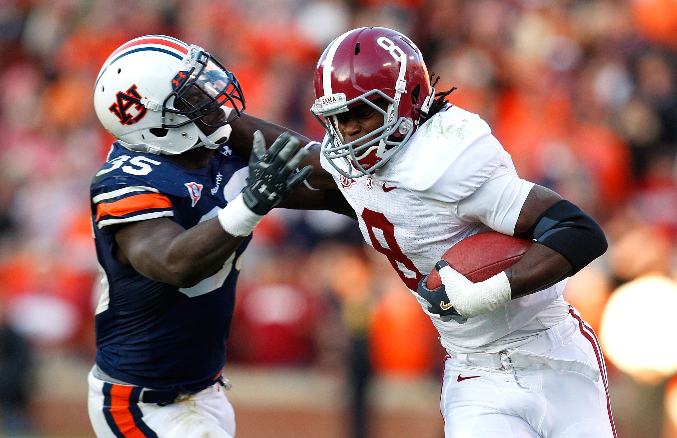 AUBURN, AL - NOVEMBER 27:  Julio Jones #8 of the Alabama Crimson Tide tries to break a tackle by Jonathan Evans #35 of the Auburn Tigers at Jordan-Hare Stadium on November 27, 2009 in Auburn, Alabama.  (Photo by Kevin C. Cox/Getty Images)