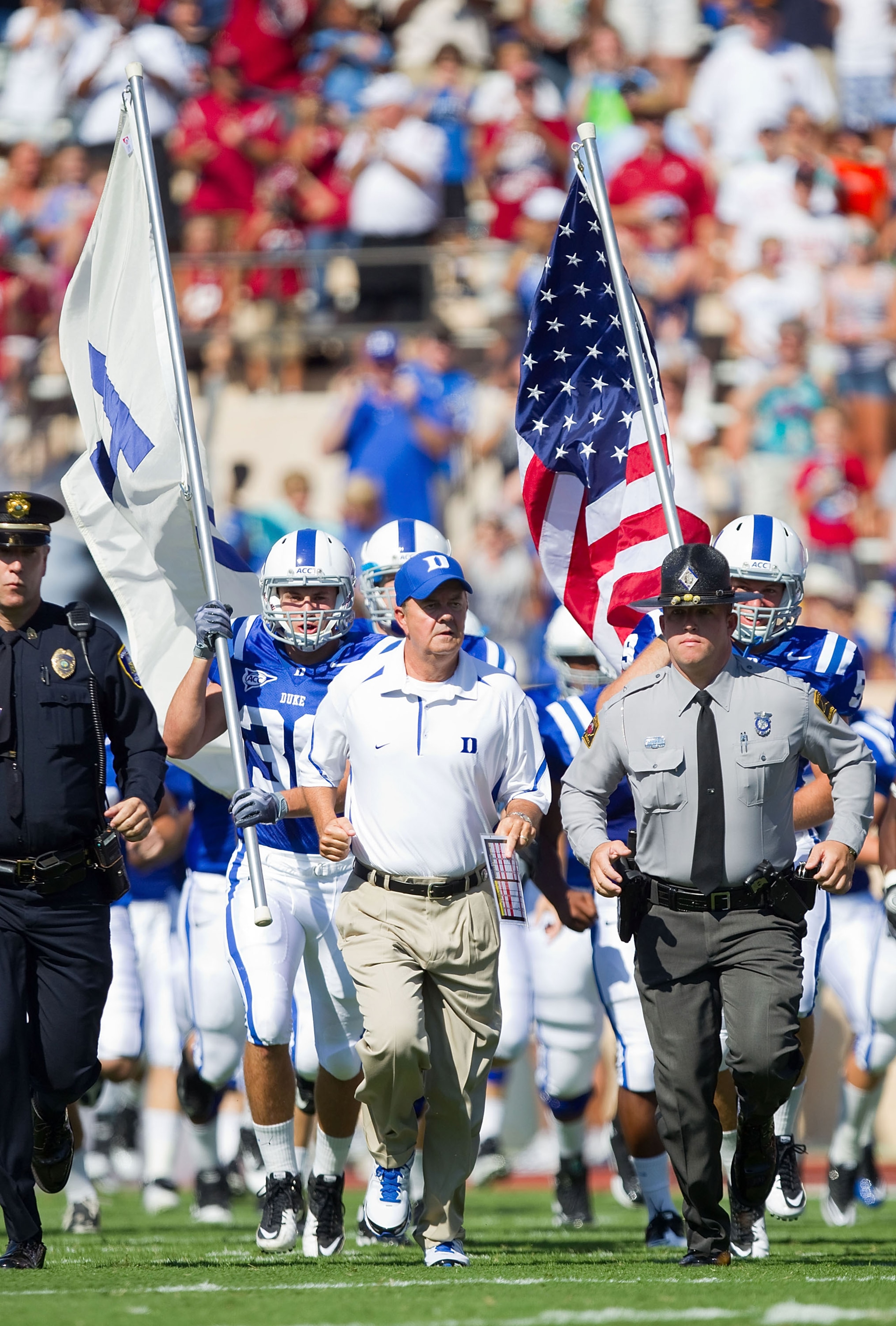DURHAM, NC - SEPTEMBER 18: Duke Blue Devils head coach David Cutcliffe (C) leads his team on to the field to take on the Alabama Crimson Tide at Wallace Wade Stadium on September 18, 2010 in Durham, North Carolina.  The Crimson Tide defeated the Blue Devi