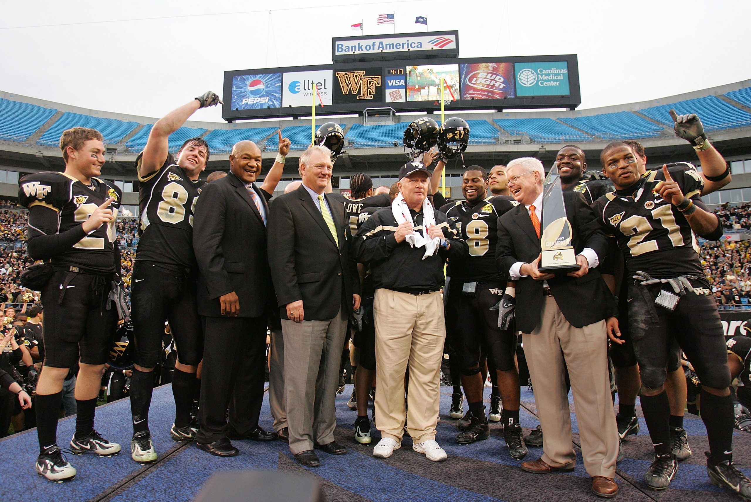 CHARLOTTE, NC - DECEMBER 29:  Head coach Jim Grobe of the Wake Forest Demon Deacons stands with his team to accept the winner's trophy after defeating the Connecticut Huskies 24-10 at Bank of America Stadium on December 29, 2007 in Charlotte, North Caroli