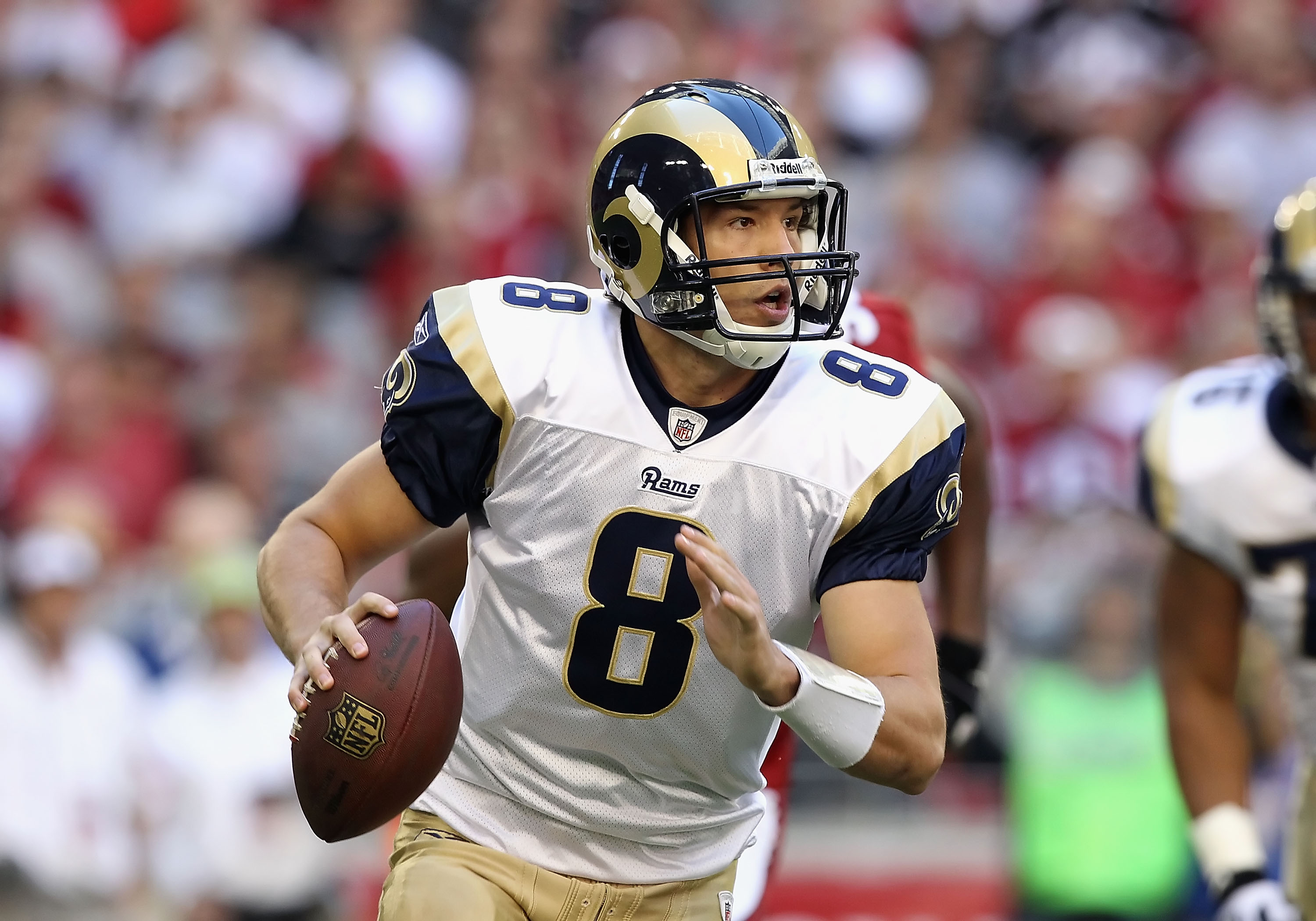 GLENDALE, AZ - DECEMBER 05:  Quarterback Sam Bradford #8 of the St. Louis Rams scrambles to pass the football during the NFL game against the Arizona Cardinals at the University of Phoenix Stadium on December 5, 2010 in Glendale, Arizona. The Rams defeate